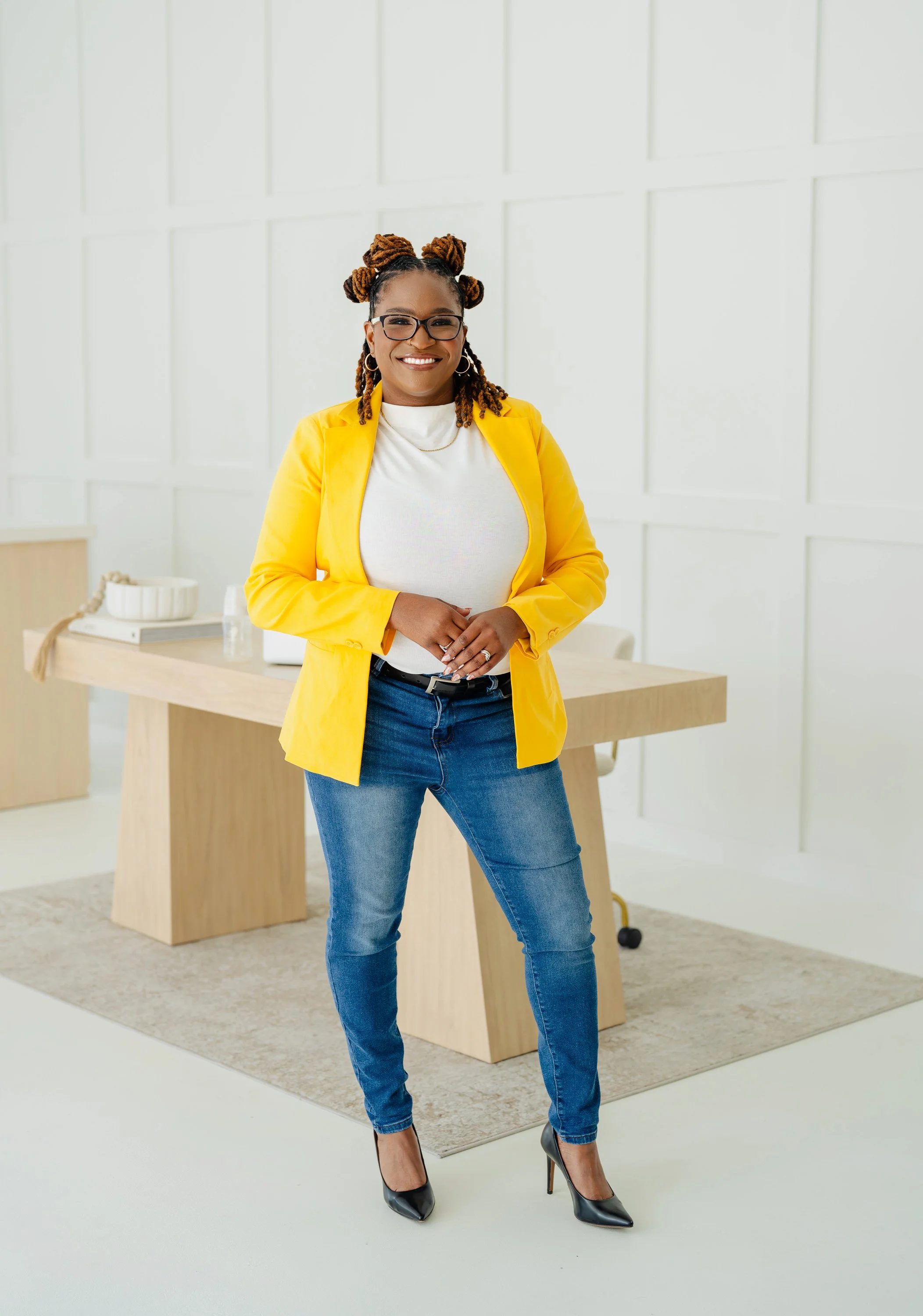 Courtney Skipworth, IBCLC and founder of Picture Perfect Latch, standing confidently in a bright yellow blazer, representing lactation consulting and photography services in Jacksonville, Florida.