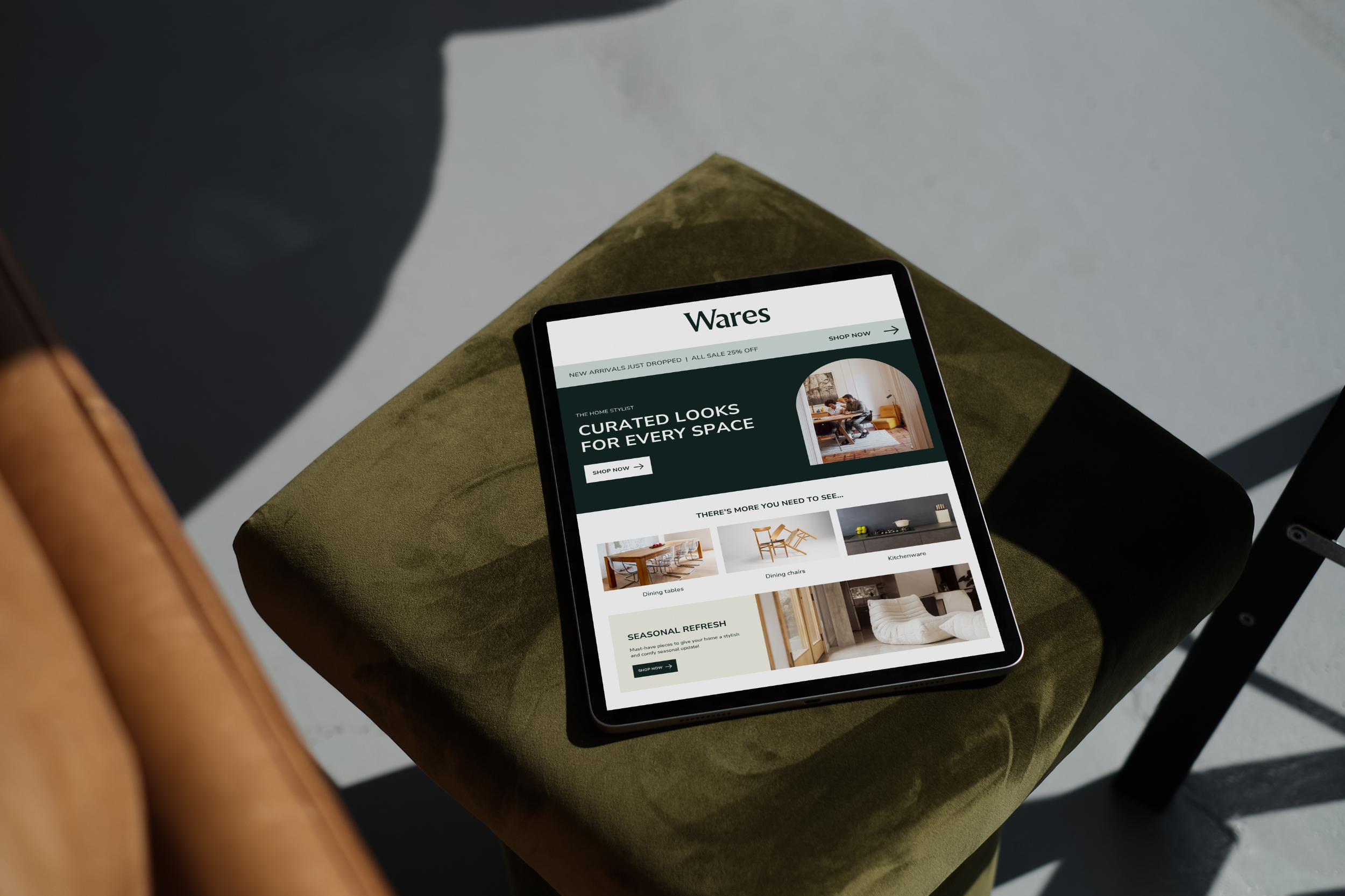 Tablet displaying online shopping website on green stool
