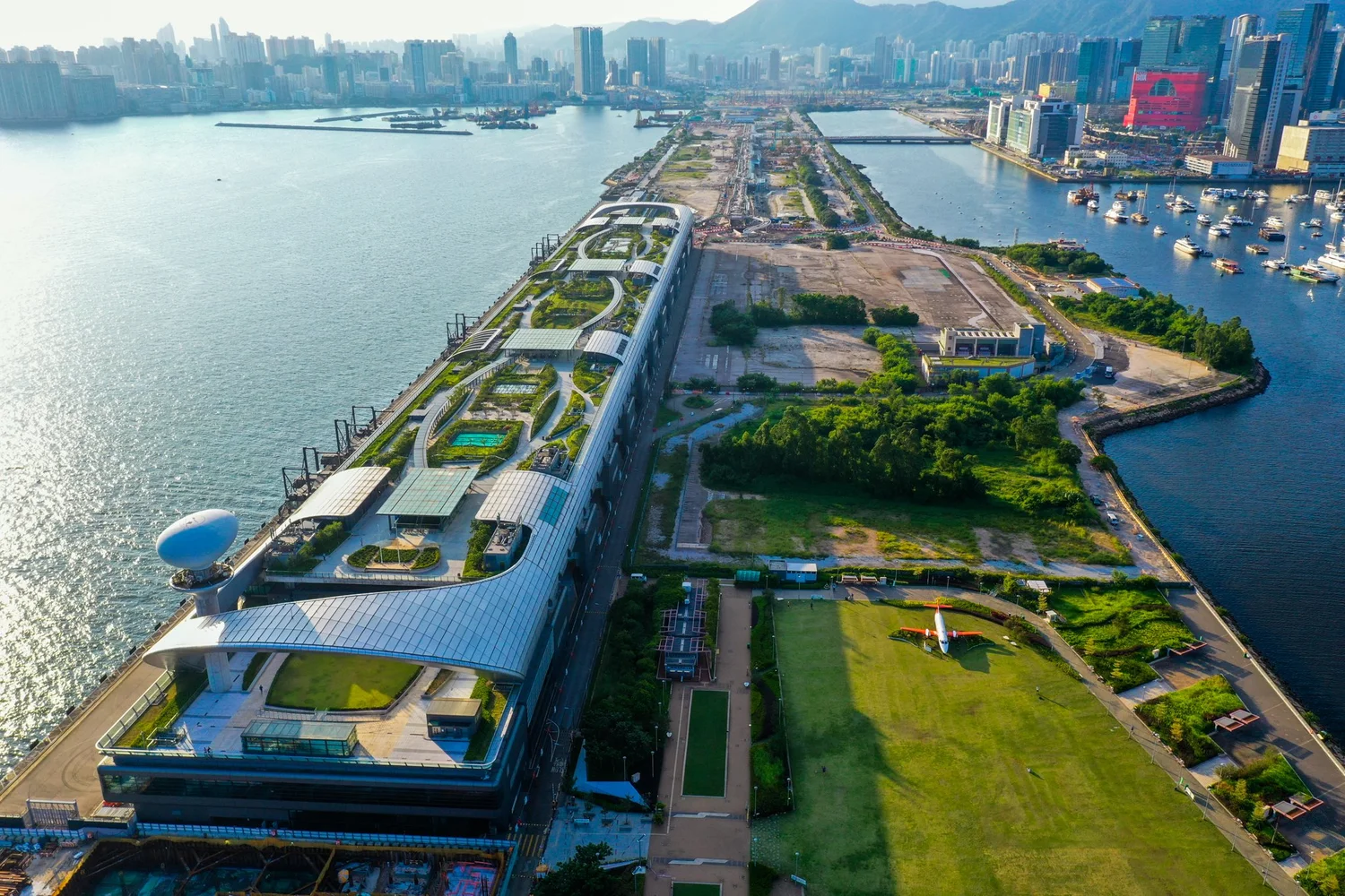 Aerial view of a waterfront park and promenade in Kowloon