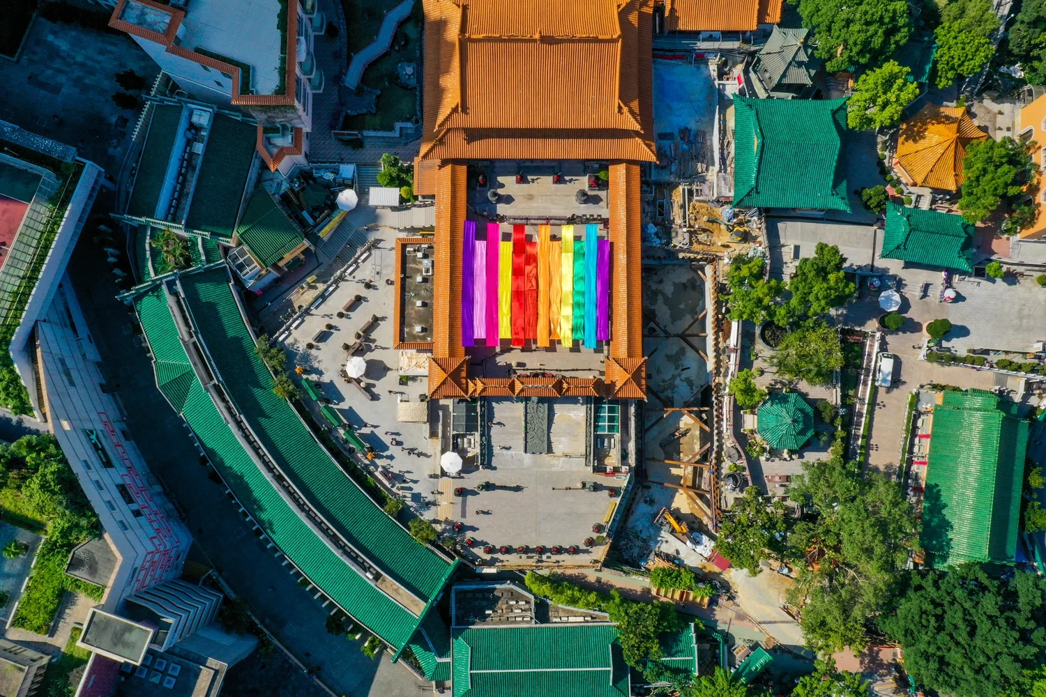 Aerial view of a rainbow-painted rooftop among buildings in Hong Kong