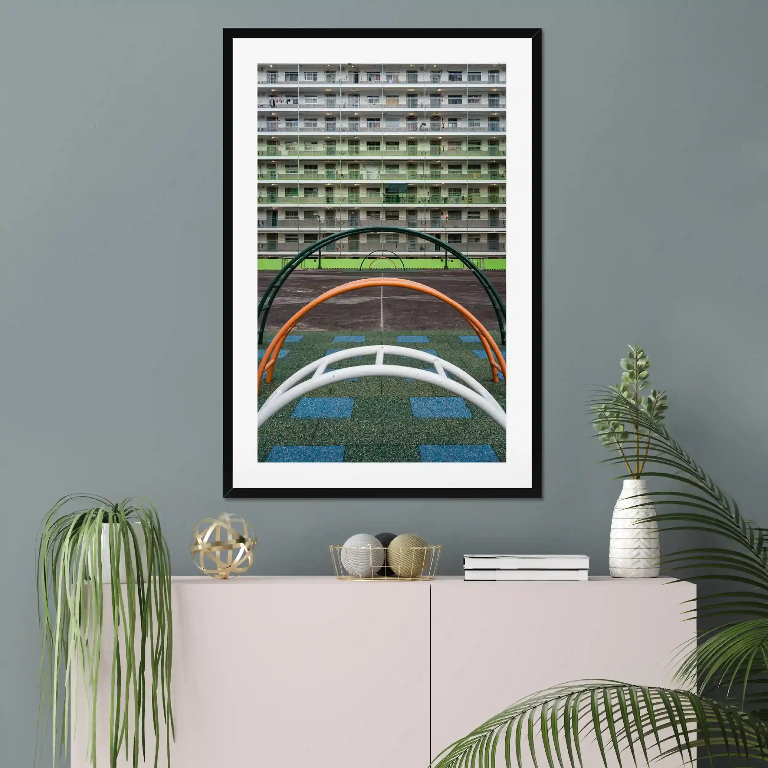 Symmetrical photography of the green residential buildings and the colorful courtyard playground at Nam Shan Estate in Hong Kong.