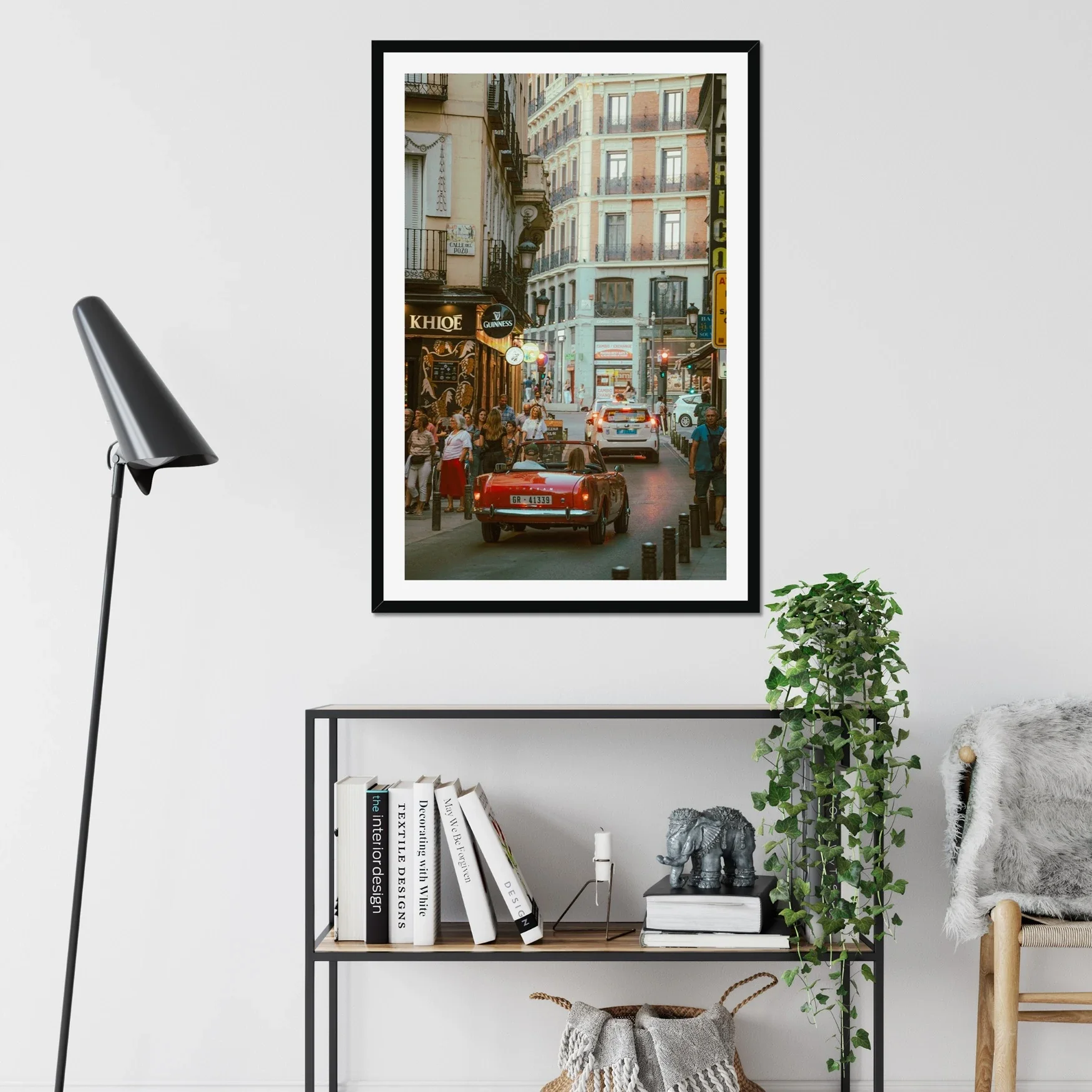 Classic red Sunbeam Alpine vintage car driving through Madrid streets at sunset, golden hour lighting, Lomography X-Pro film style photography, retro Spanish urban scene.