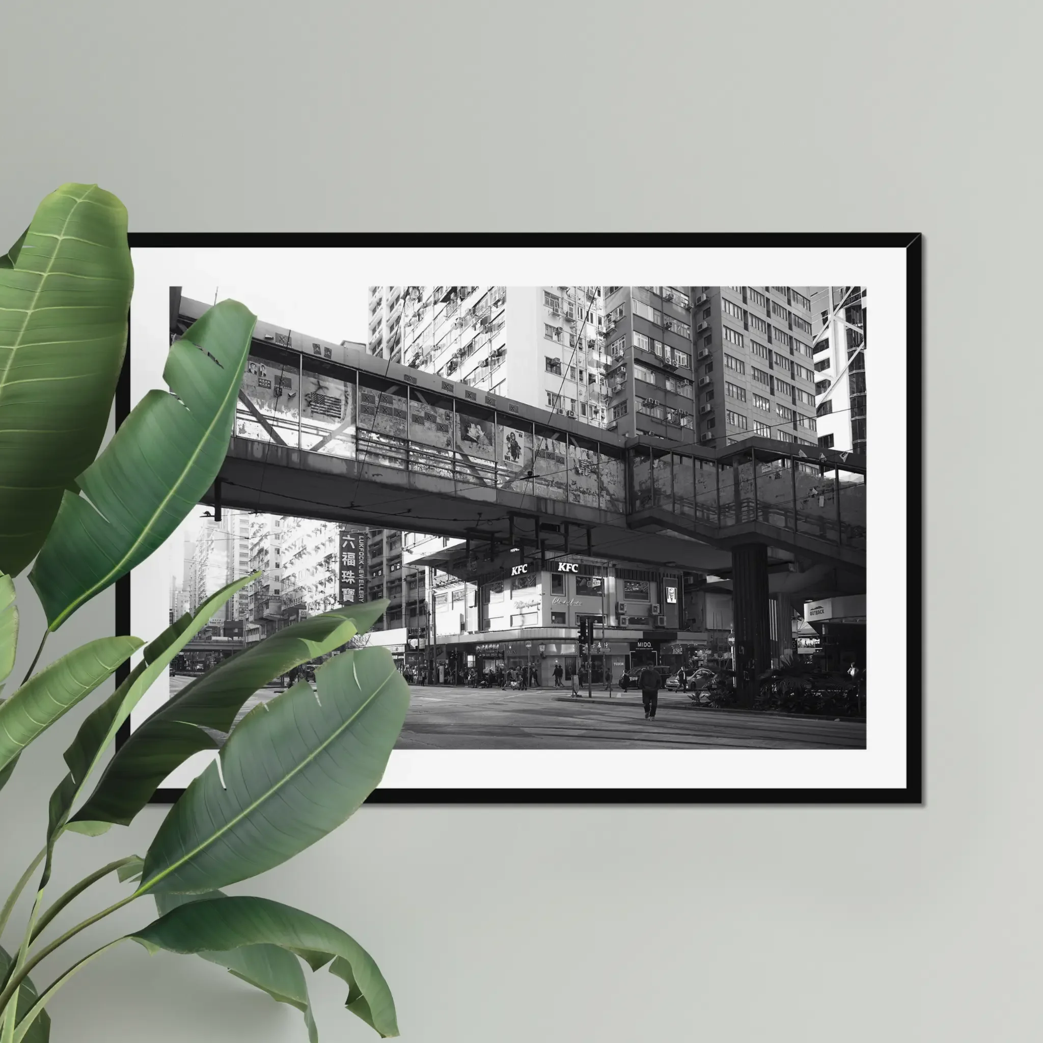 Black and white street photography print of a solitary figure walking through a narrow Hong Kong alley in a dramatic shaft of light. High-contrast cinematic Noir fine art wall decor.