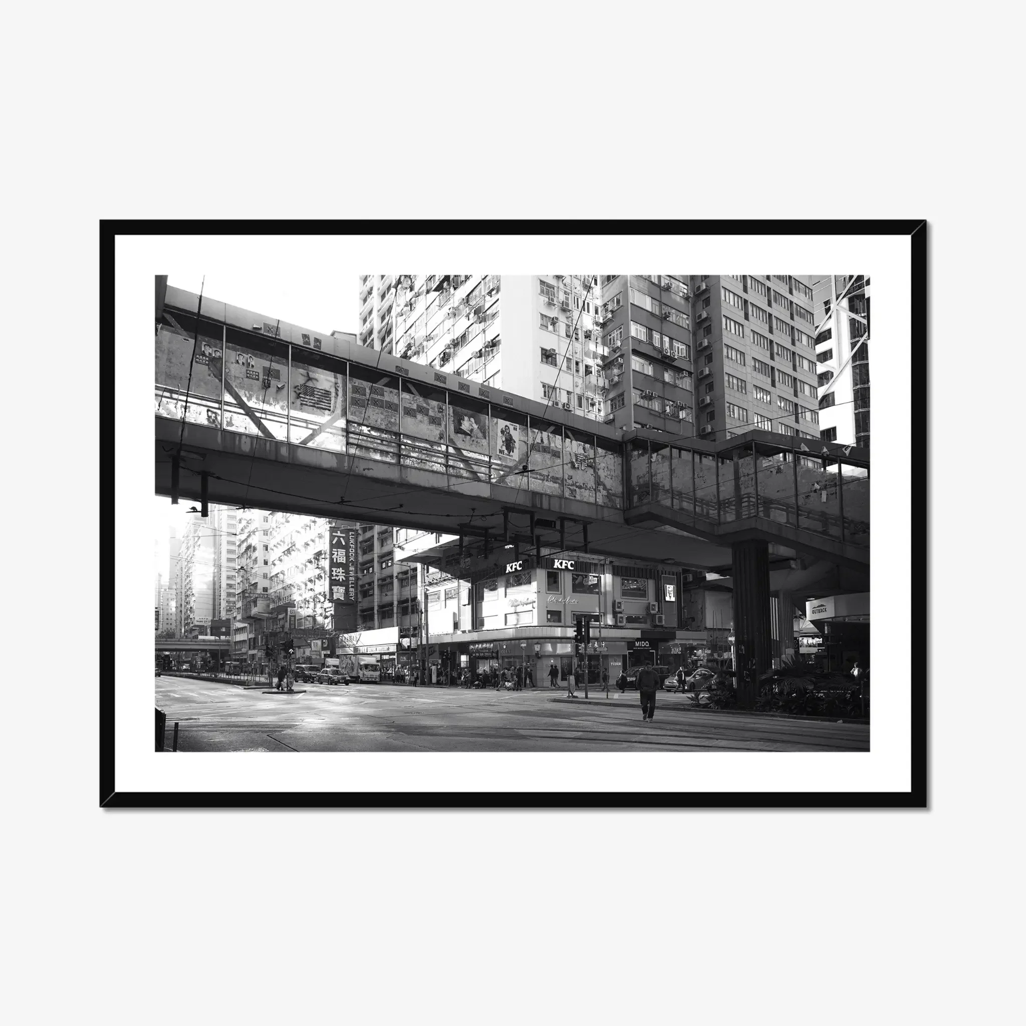 Black and white street photography print of a solitary figure walking through a narrow Hong Kong alley in a dramatic shaft of light. High-contrast cinematic Noir fine art wall decor.