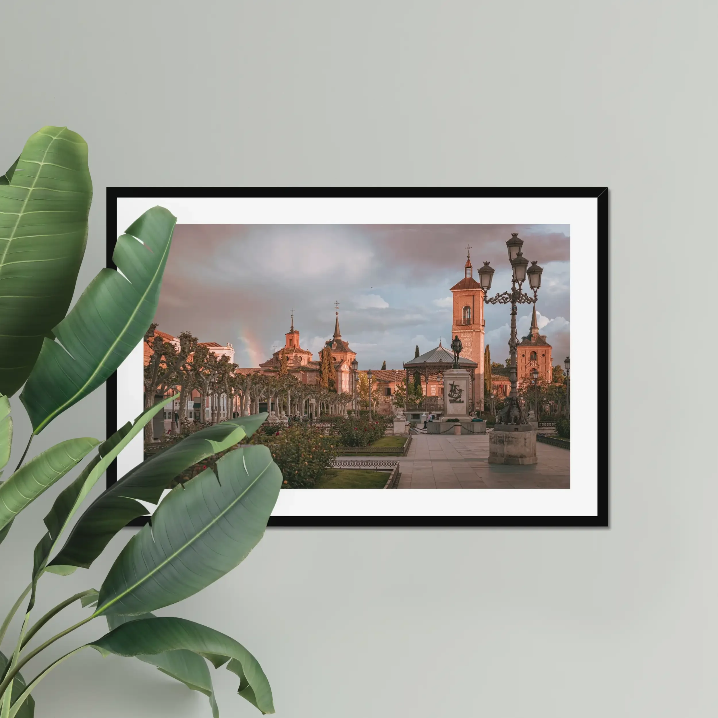 Fine art photography of Plaza de Cervantes in Alcala de Henares, Madrid, featuring a rainbow and dramatic stormy sunset over the historic square.