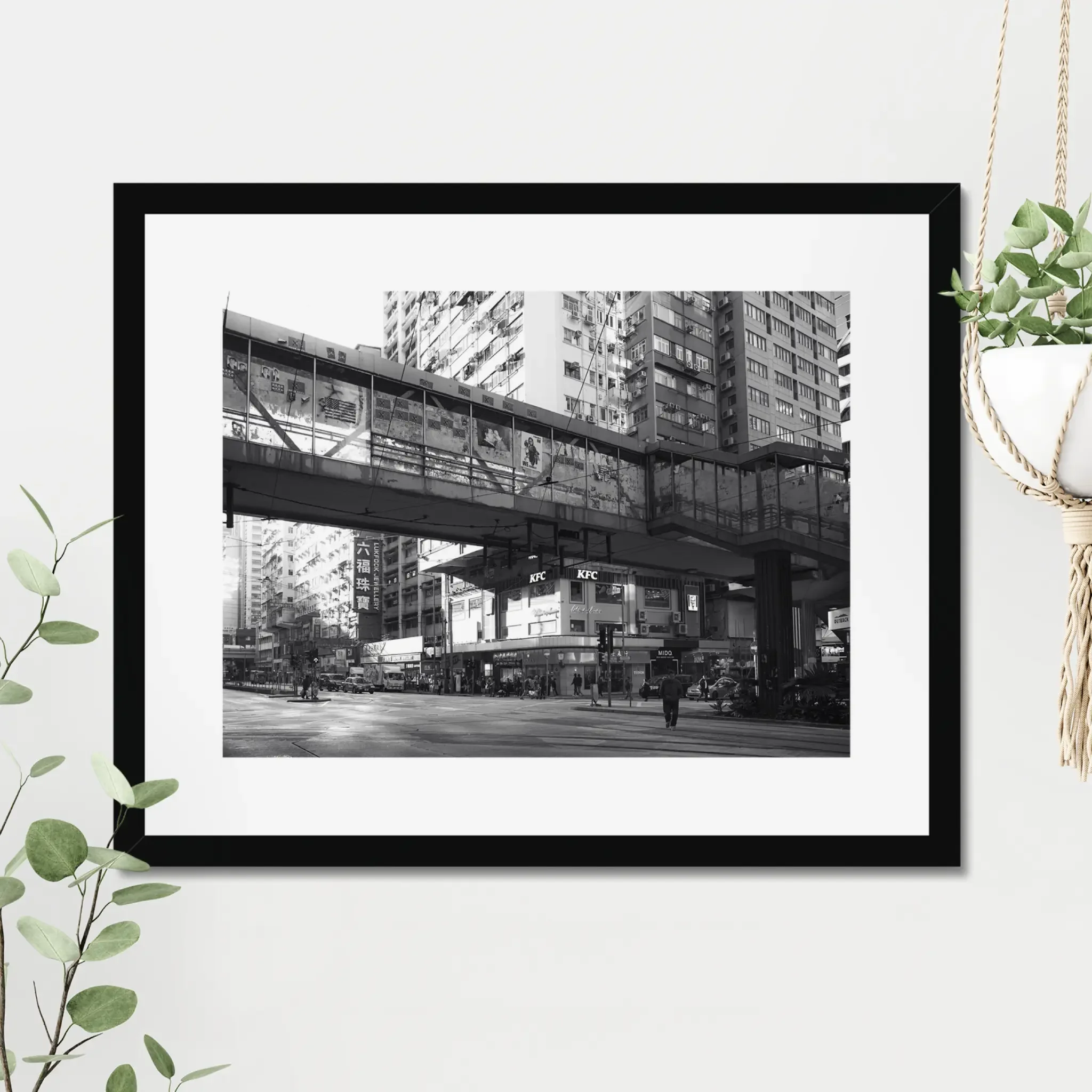 Black and white street photography print of a solitary figure walking through a narrow Hong Kong alley in a dramatic shaft of light. High-contrast cinematic Noir fine art wall decor.