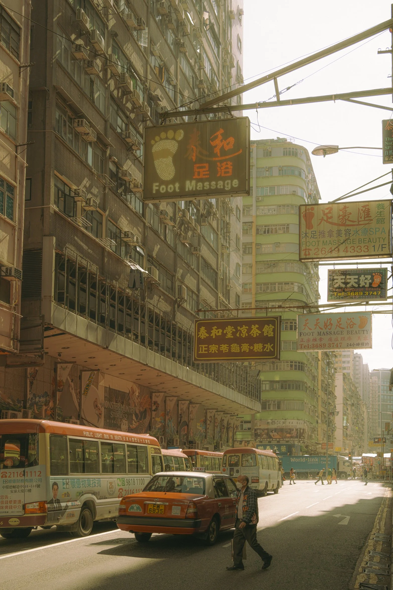 Sun-drenched Hong Kong street photography fine art print. Cinematic urban scene with vintage signs, a red taxi, and a solitary pedestrian crossing. Warm wall art decor.