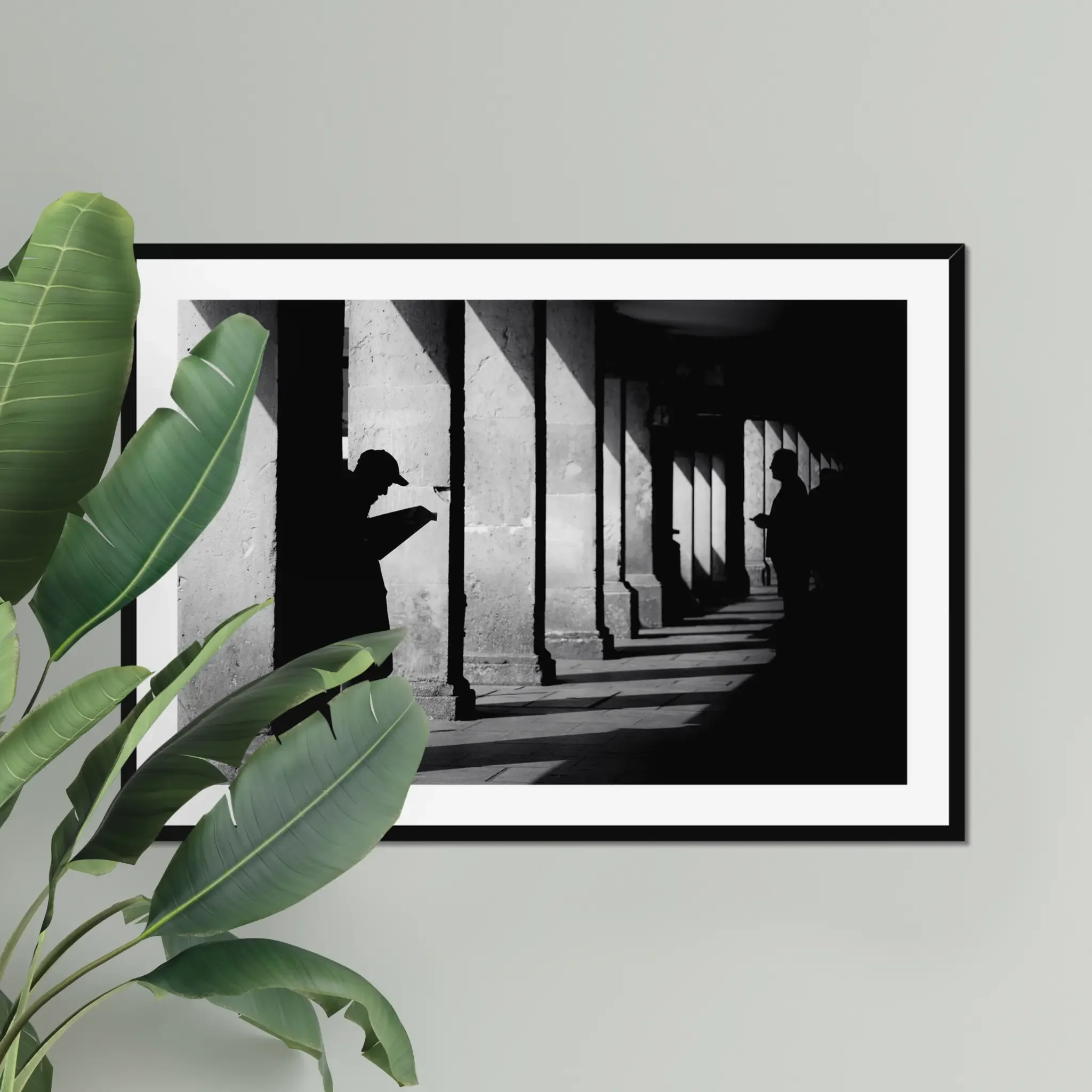 Black and white minimalist street photography print of a lone figure walking up an outdoor staircase. Features strong geometric lines and high-contrast dramatic shadows. Fine art wall decor.