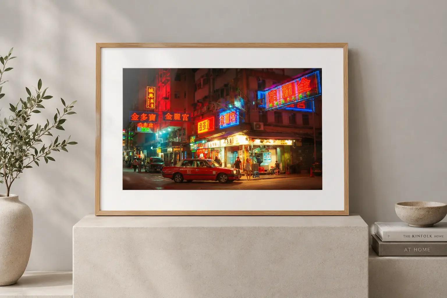 Red Hong Kong taxi parked at a night street corner beneath glowing red, blue and pink neon signs, with a street food stall and pedestrians in the background
