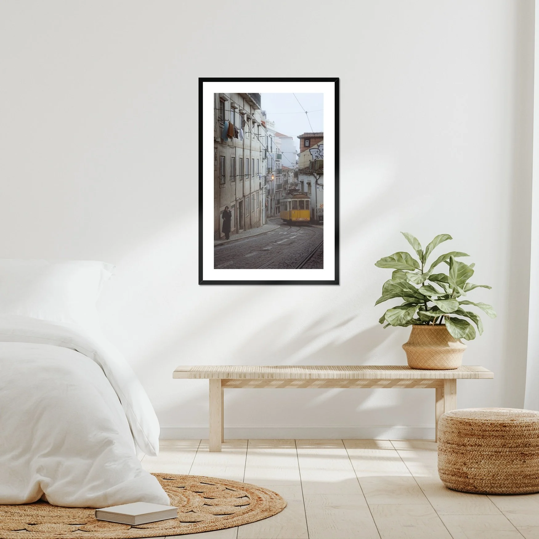 Black and white or muted tone photography of a Lisbon tram in Alfama street, winding cobblestone road with a person walking, minimalist Portuguese urban wall art.