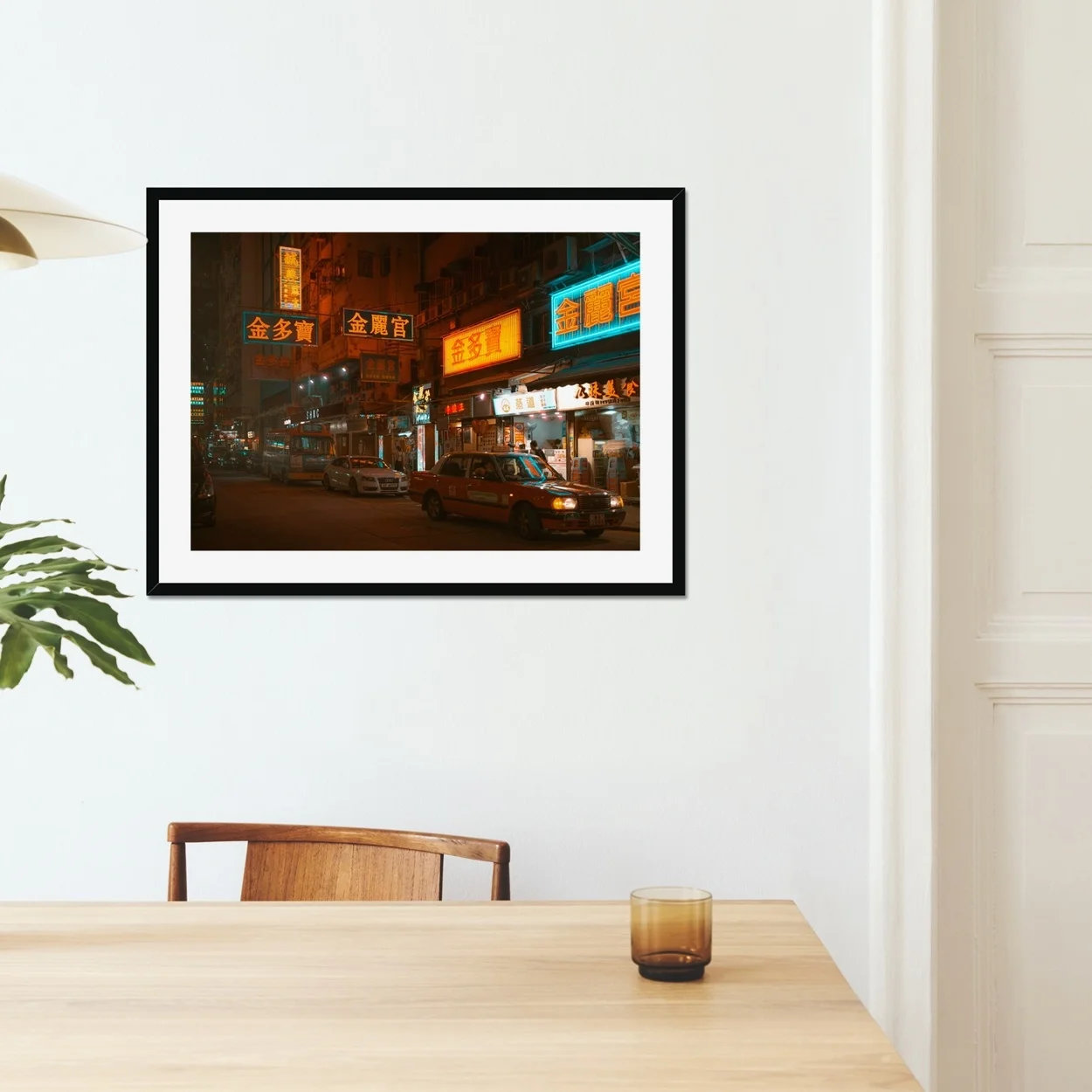 Night street photography of a red taxi in Mongkok, Hong Kong, surrounded by vibrant glowing neon signs and city lights.
