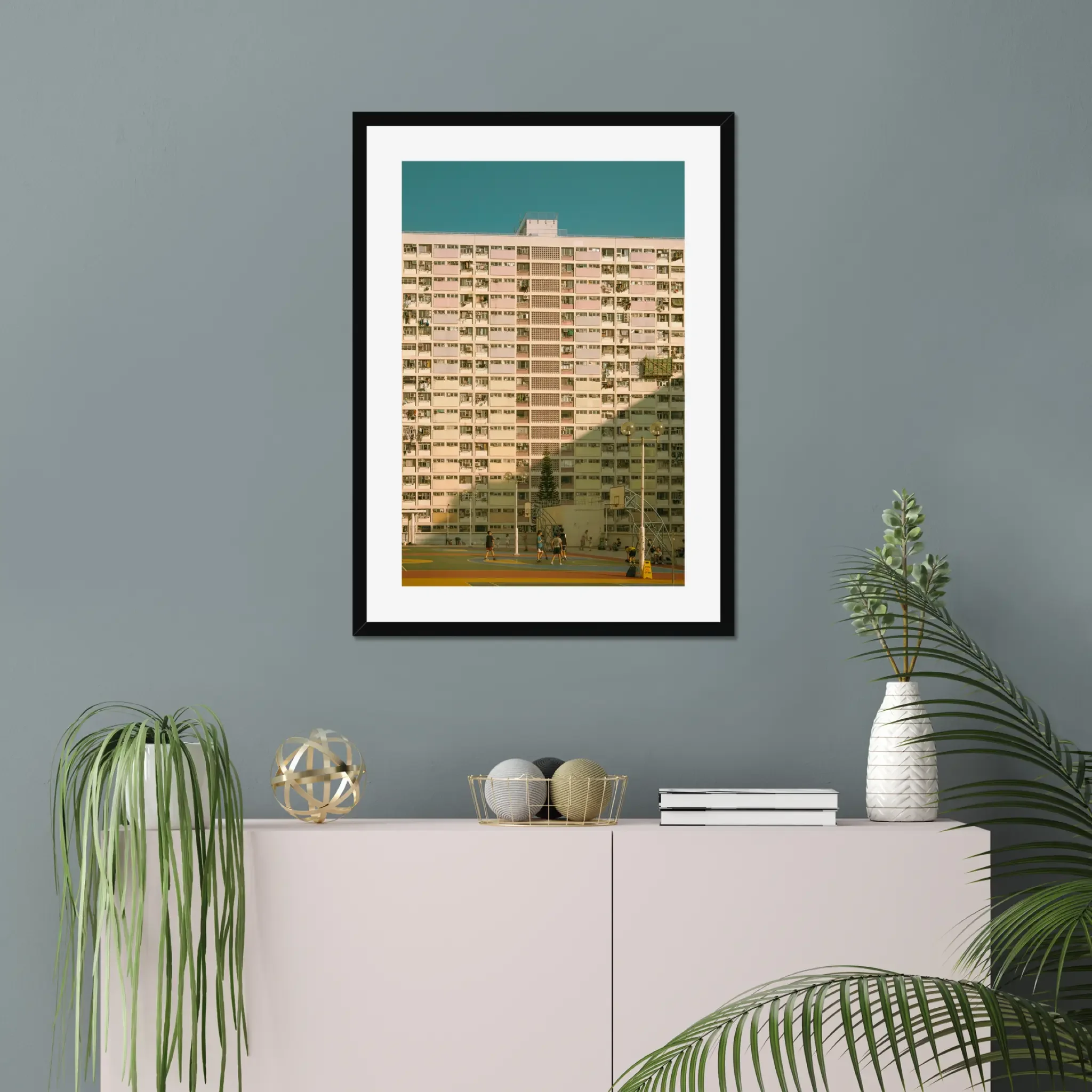 Vintage pastel building of Choi Hung Estate in Hong Kong with a colorful basketball court at golden hour.