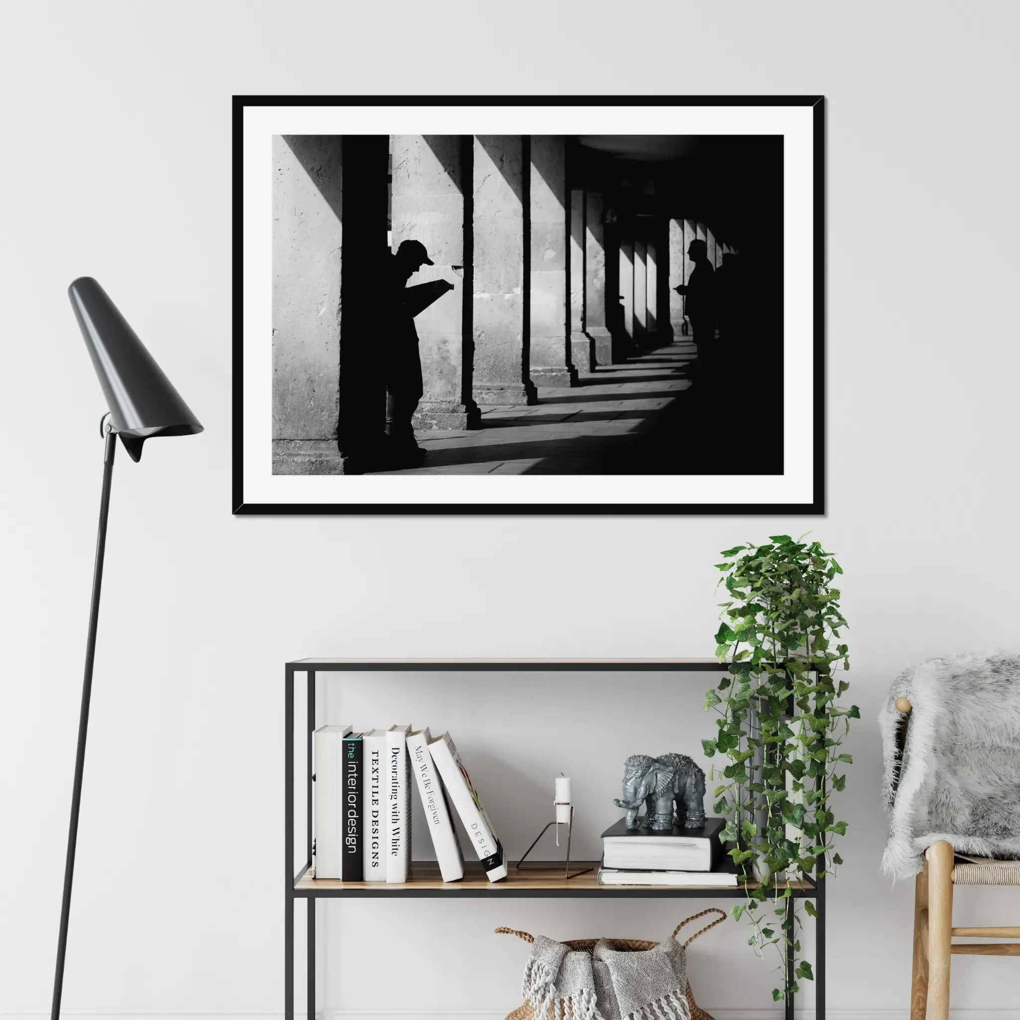 Black and white minimalist street photography print of a lone figure walking up an outdoor staircase. Features strong geometric lines and high-contrast dramatic shadows. Fine art wall decor.