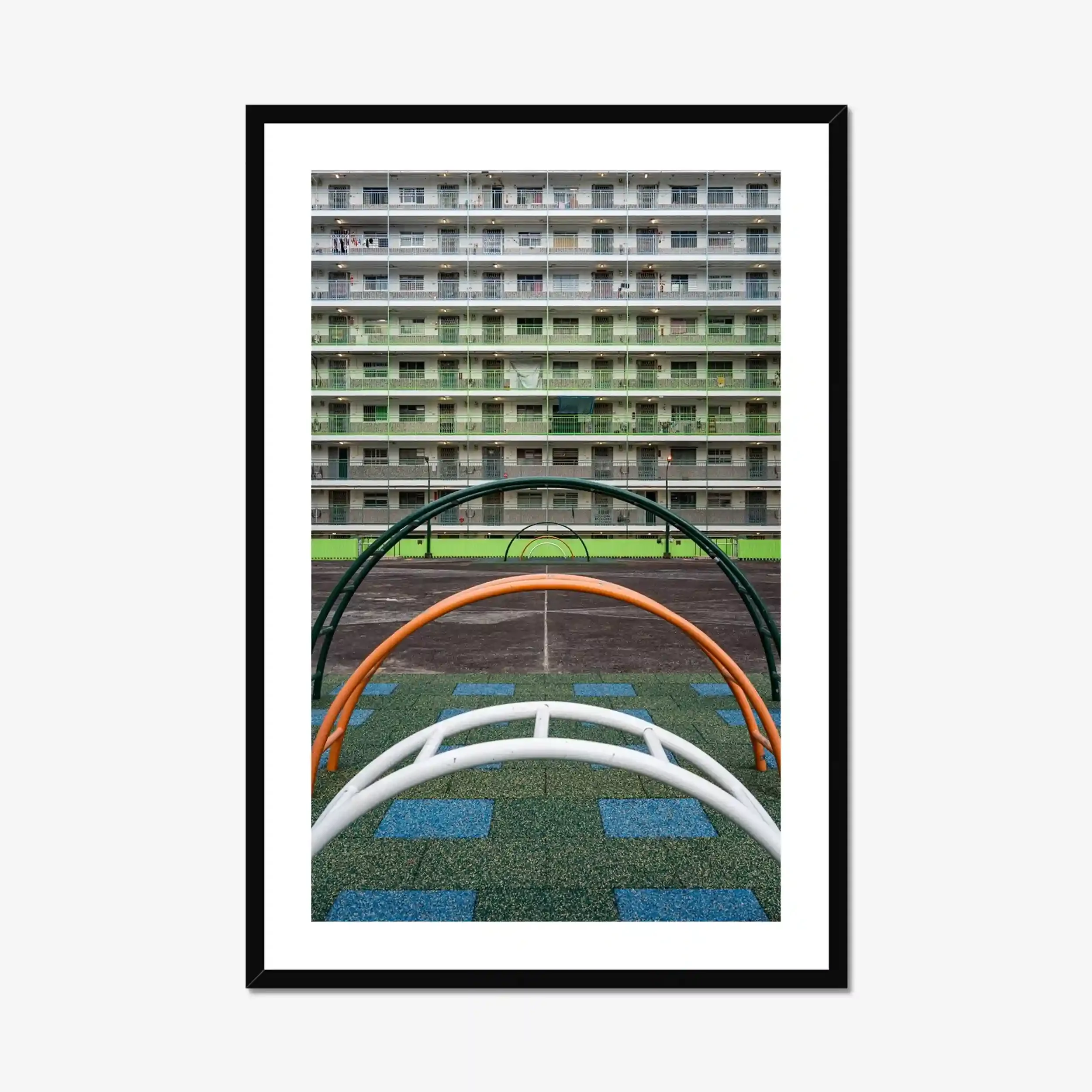 Symmetrical photography of the green residential buildings and the colorful courtyard playground at Nam Shan Estate in Hong Kong.