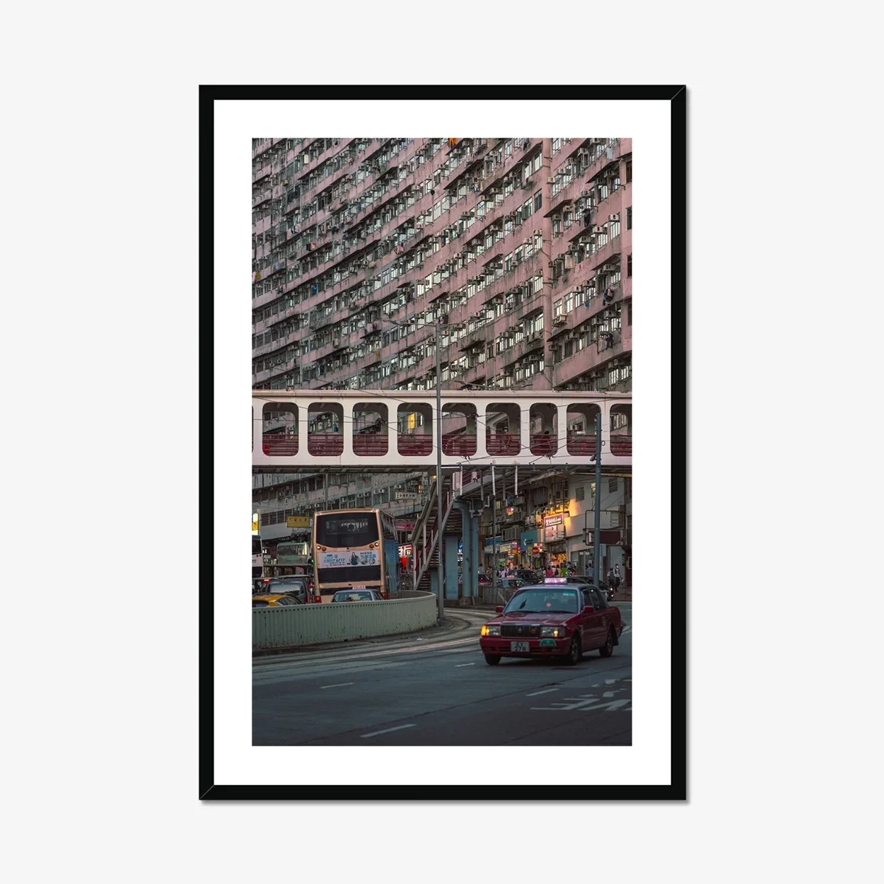 Street photography of a red taxi driving through Quarry Bay, Hong Kong, with historic residential buildings in the background at sunset.