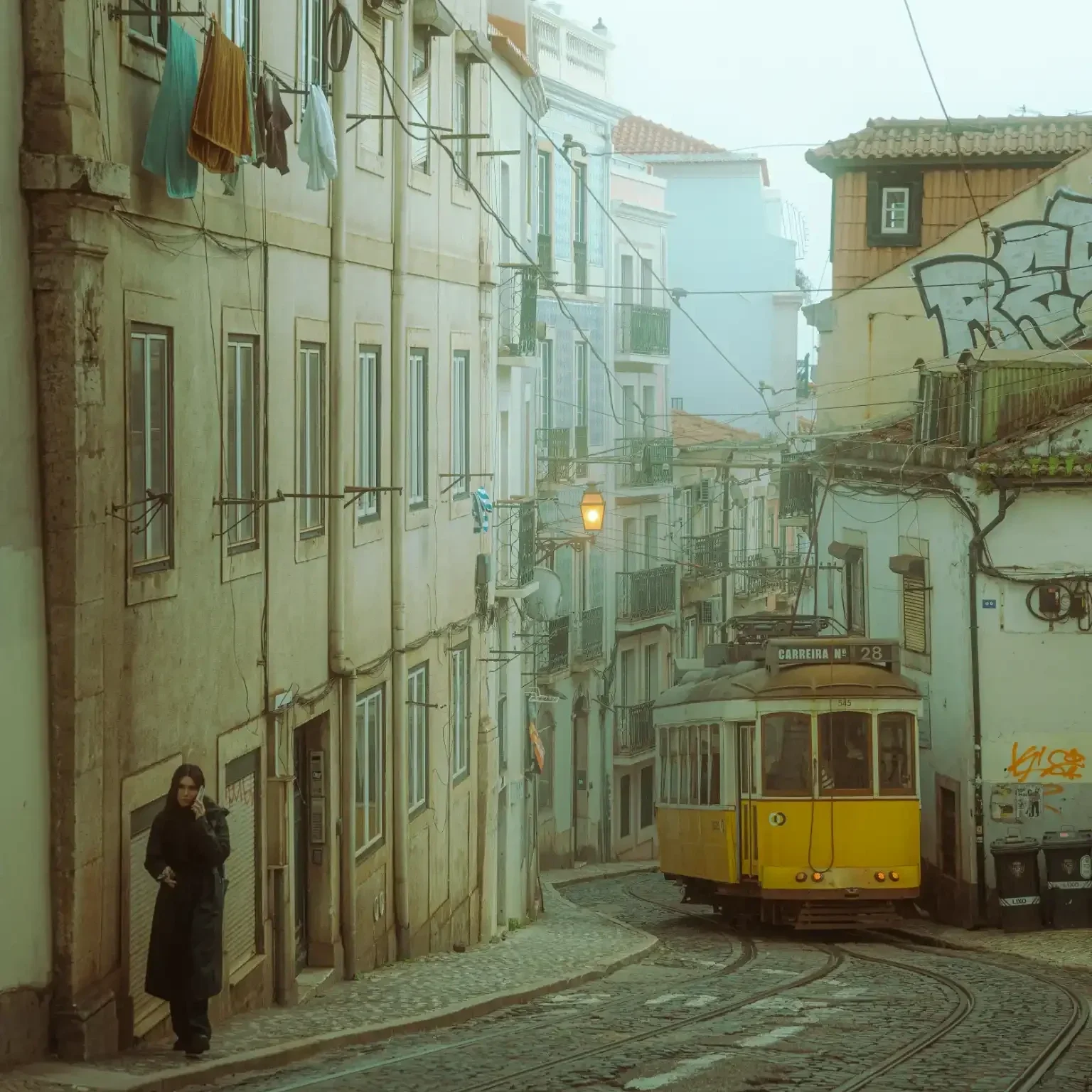 Vintage yellow tram on a misty Lisbon street. Moody cinematic fine art print