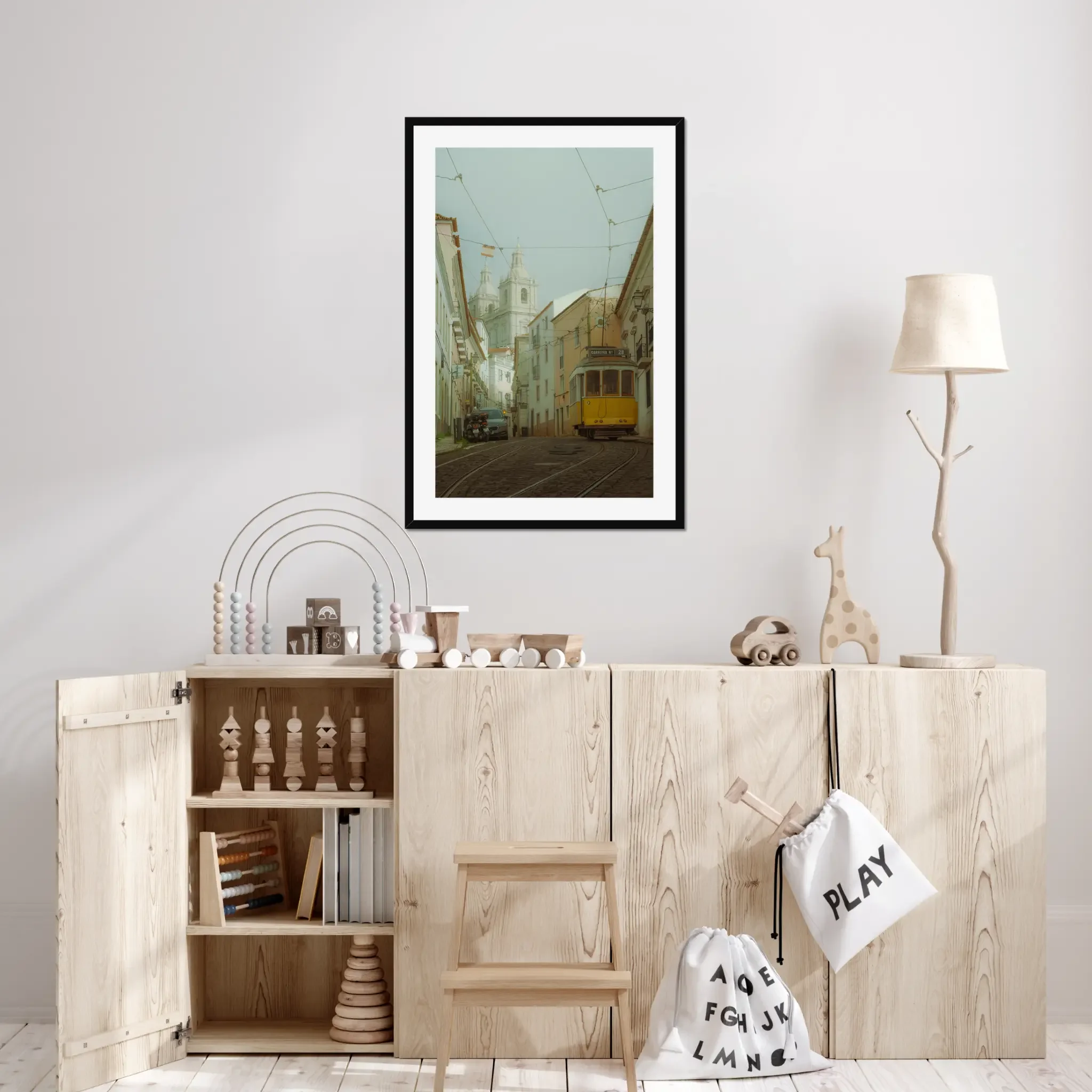 ejduranphotography Fine Art Lisbon print. Cinematic street photography of the iconic yellow Tram 28 on a winding cobblestone street with a misty church background. Moody wall art decor.