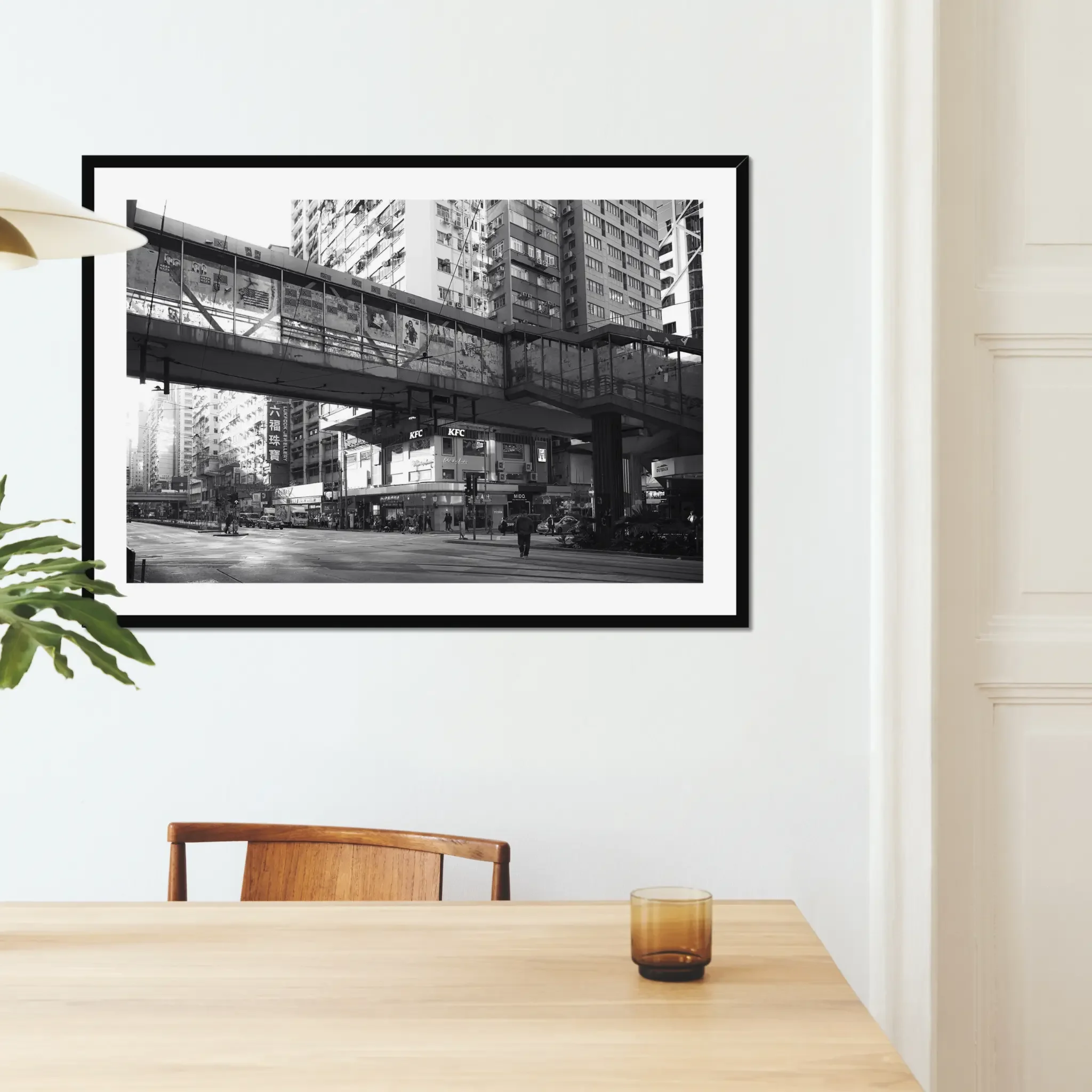 Black and white street photography print of a solitary figure walking through a narrow Hong Kong alley in a dramatic shaft of light. High-contrast cinematic Noir fine art wall decor.