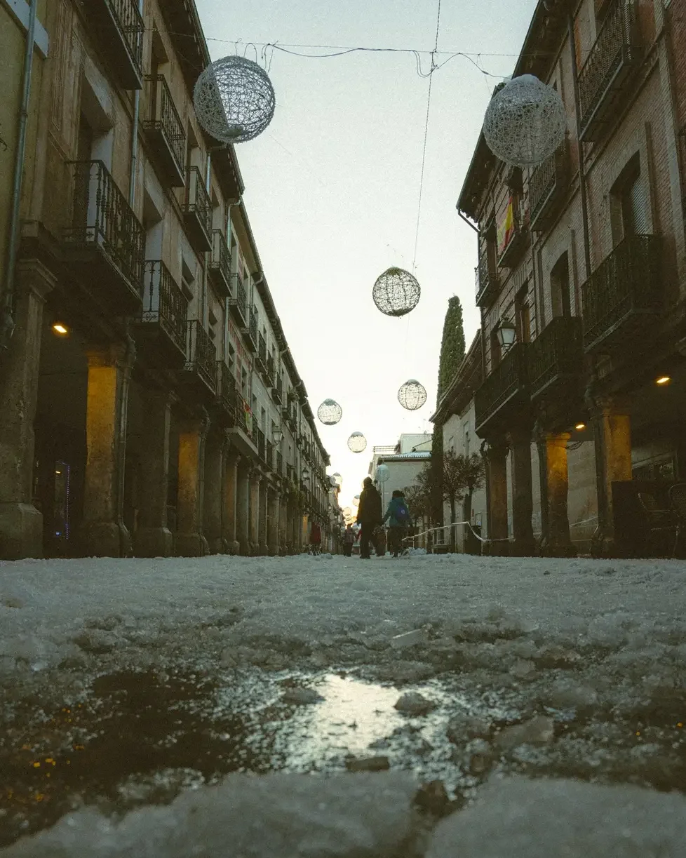 Before and after comparison using Lomography 800 Lightroom preset on a night street photography scene with vibrant neon lights and film grain.