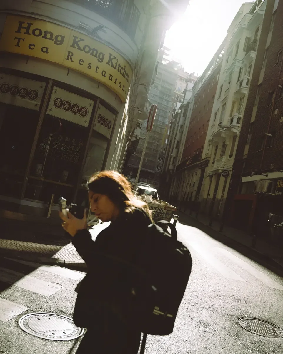 Before and after comparison of Kodak Pro 100 Lightroom preset showing soft contrast and warm film tones on a daylight portrait.