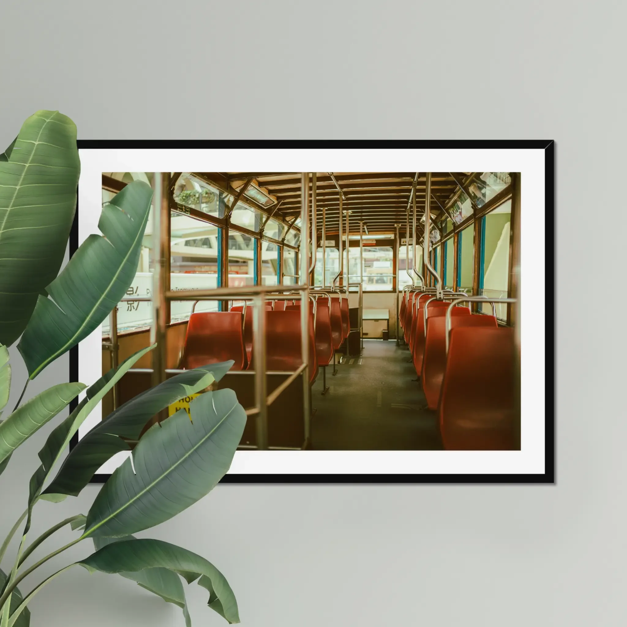 Vintage Hong Kong tram interior fine art print featuring red seats and a hold the handrails sign in warm cinematic tones.