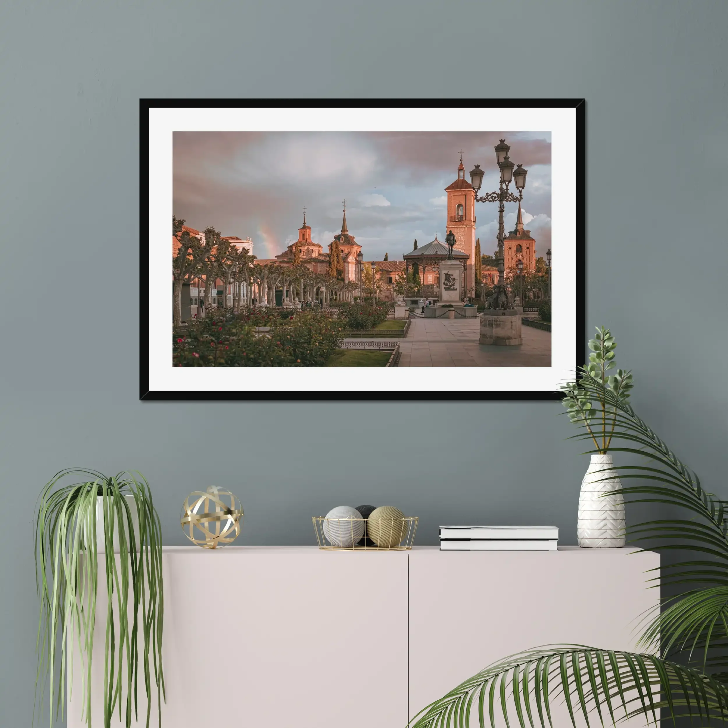 Fine art photography of Plaza de Cervantes in Alcala de Henares, Madrid, featuring a rainbow and dramatic stormy sunset over the historic square.