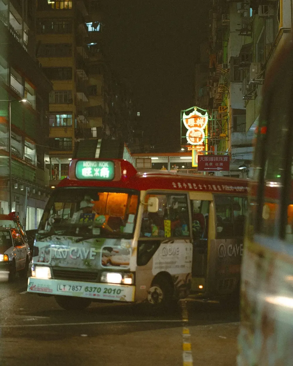 Before and after comparison using Lomography 800 Lightroom preset on a night street photography scene with vibrant neon lights and film grain.