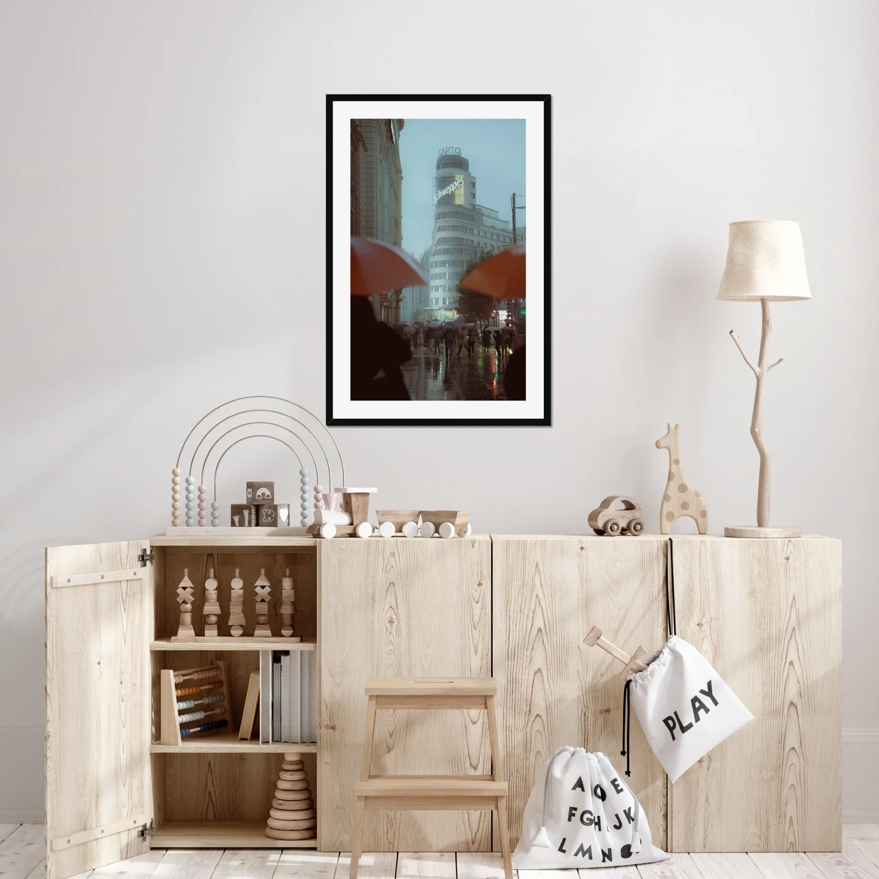 Cinematic street photography of Gran Via Madrid in the rain, featuring the Schweppes Capitol building, a sea of umbrellas, and wet street reflections at dusk.