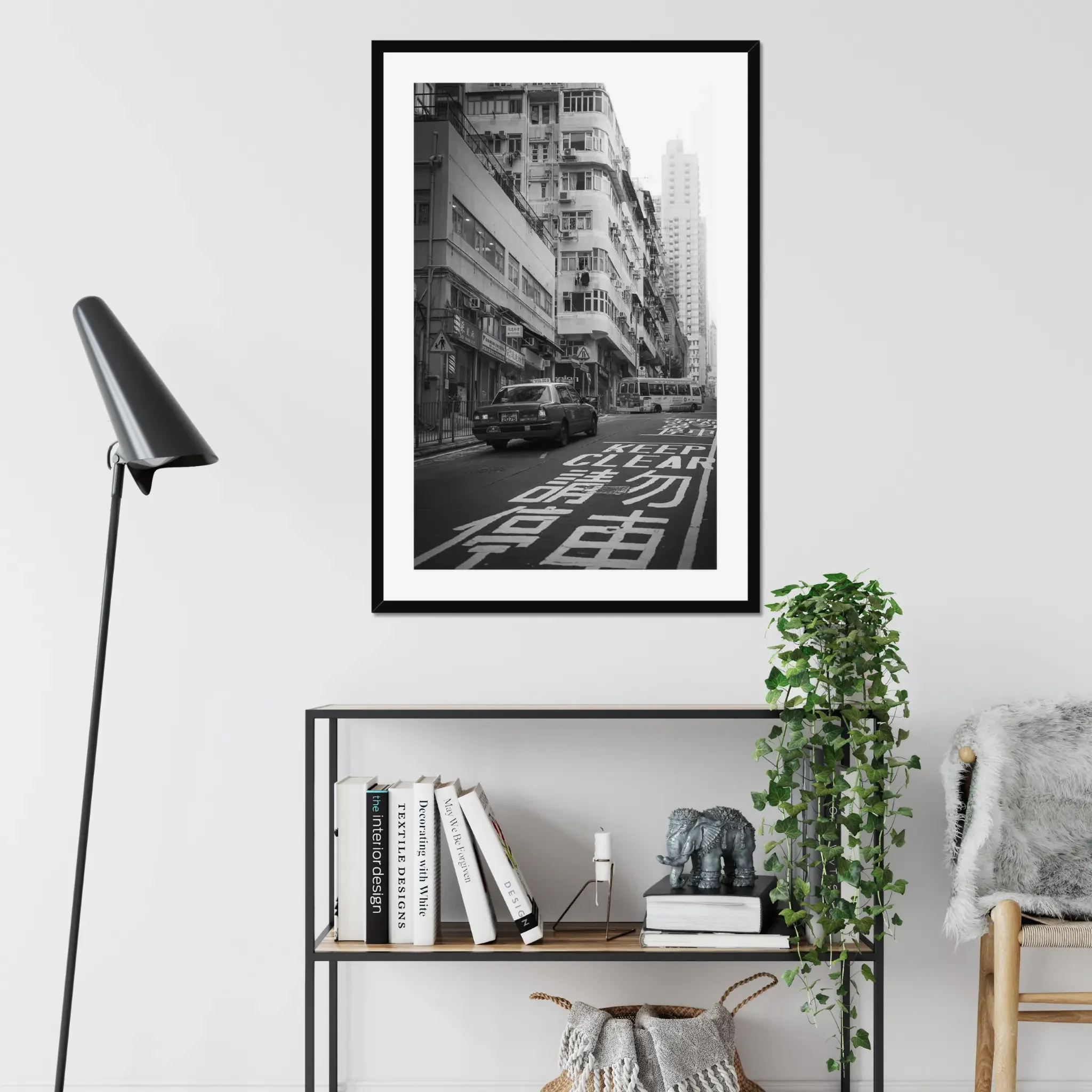 Black and white street photography print of a classic Hong Kong taxi driving up a steep hill towards a minibus. Features high-contrast shadows and strong urban geometry. Fine art wall decor