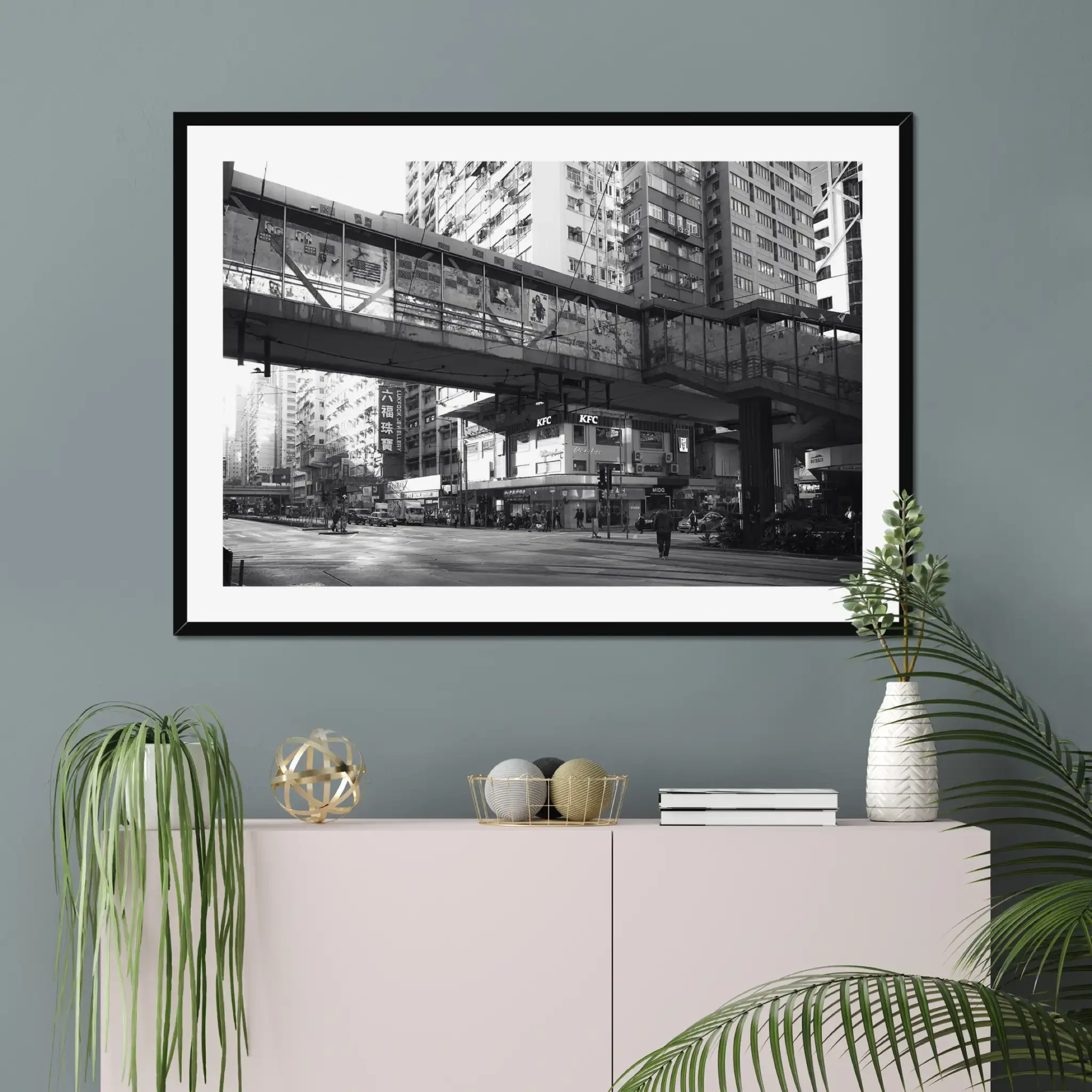Black and white street photography print of a solitary figure walking through a narrow Hong Kong alley in a dramatic shaft of light. High-contrast cinematic Noir fine art wall decor.