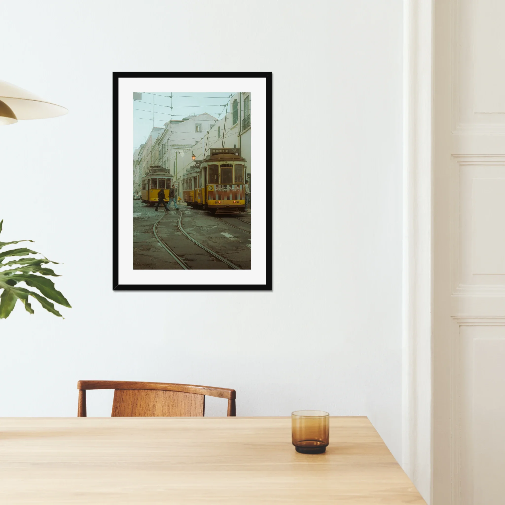 Cinematic fine art photography of Lisbon yellow Tram 28 and anonymous couple crossing tracks in moody morning fog.