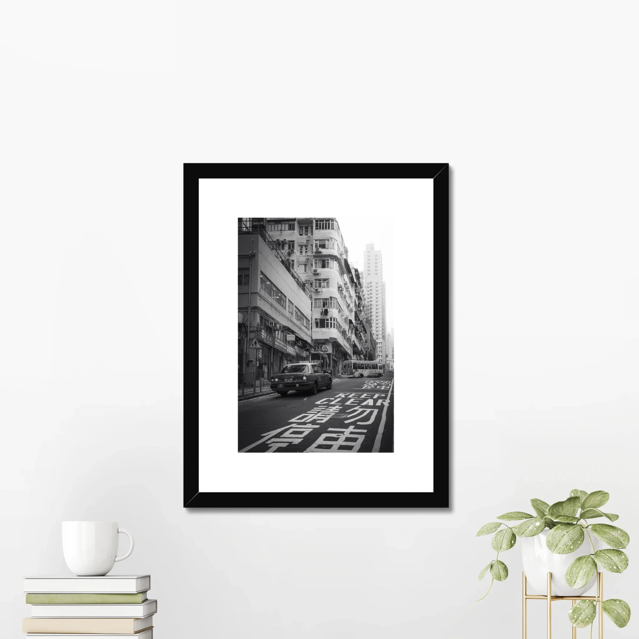 Black and white street photography print of a classic Hong Kong taxi driving up a steep hill towards a minibus. Features high-contrast shadows and strong urban geometry. Fine art wall decor