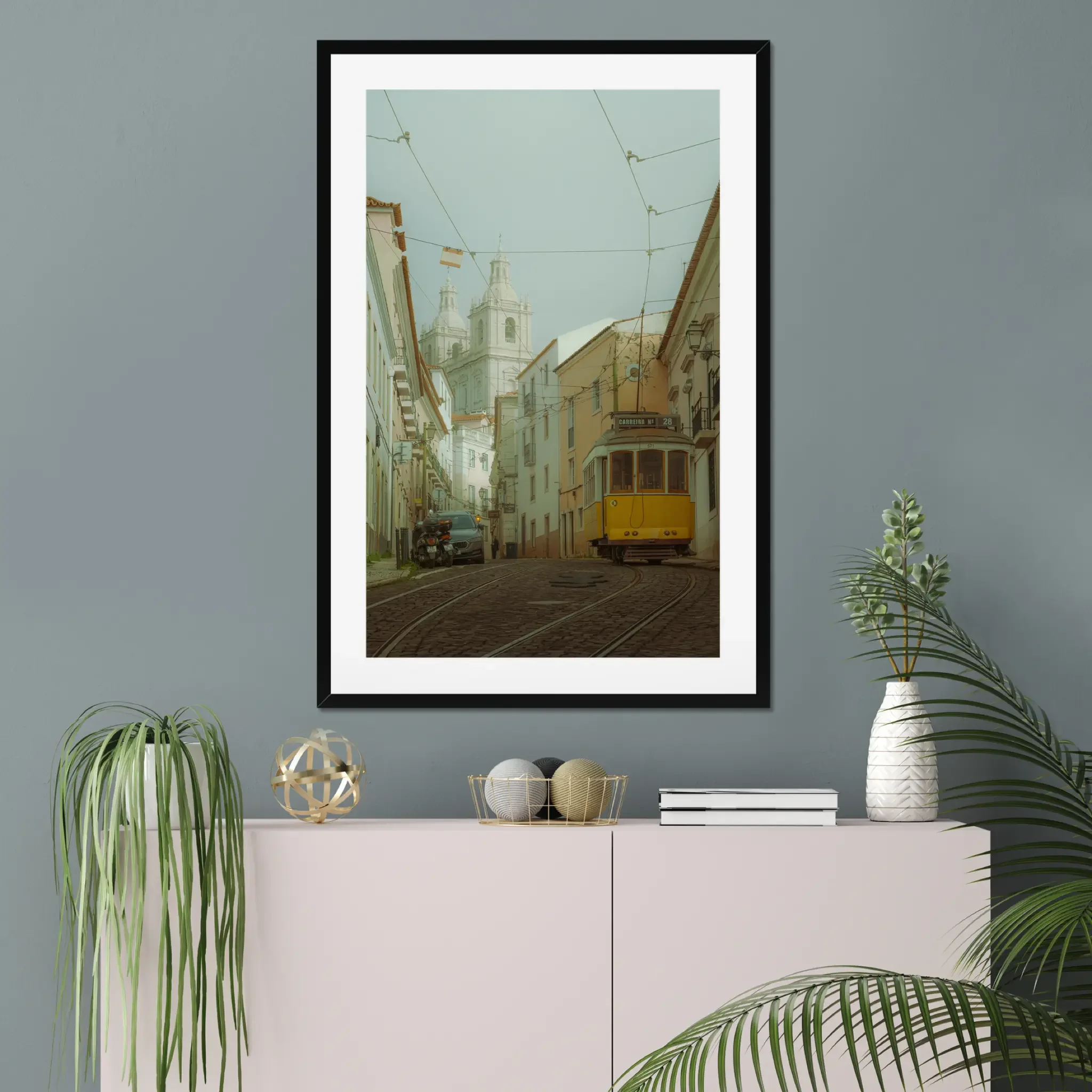 ejduranphotography Fine Art Lisbon print. Cinematic street photography of the iconic yellow Tram 28 on a winding cobblestone street with a misty church background. Moody wall art decor.