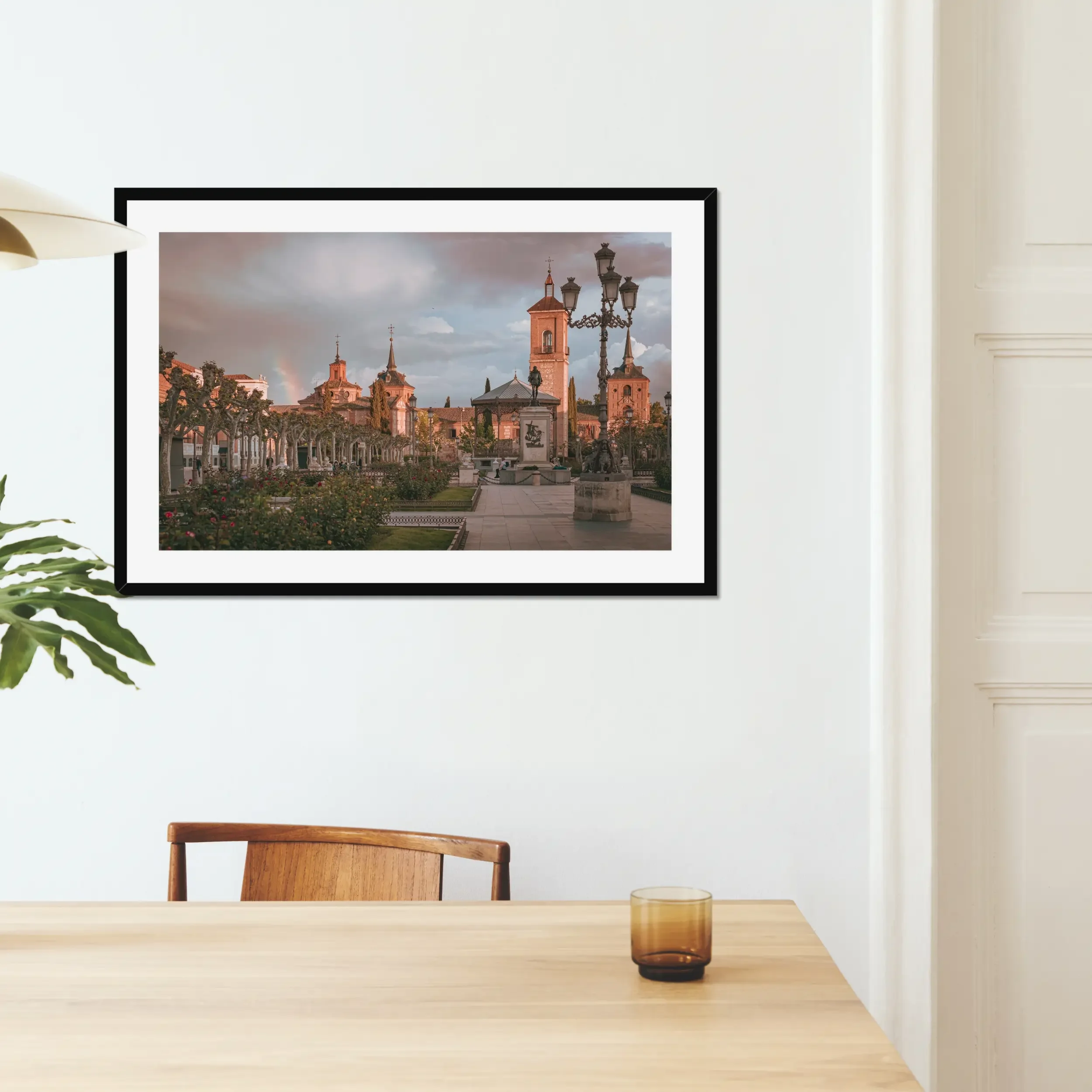 Fine art photography of Plaza de Cervantes in Alcala de Henares, Madrid, featuring a rainbow and dramatic stormy sunset over the historic square.
