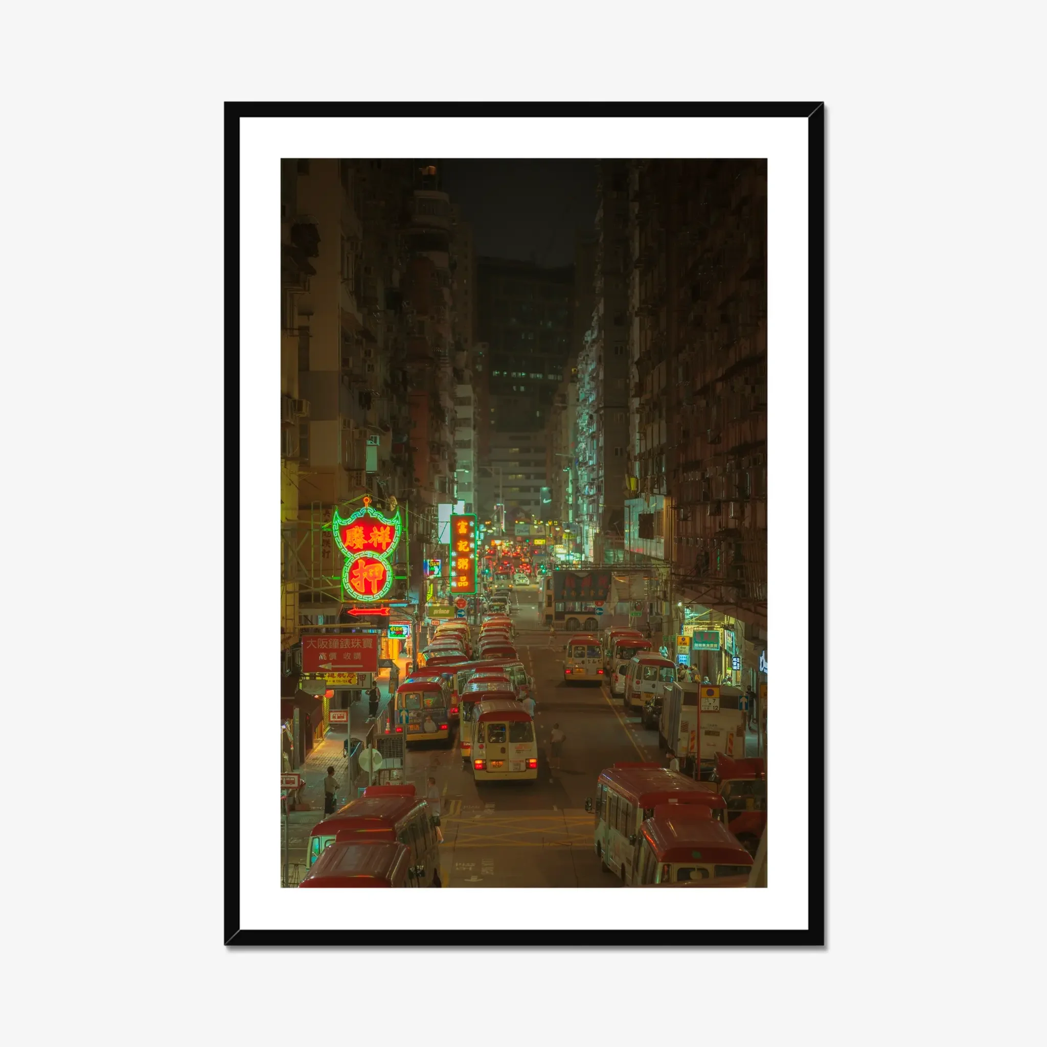 Elevated view of Hong Kong red minibuses queued on a Mong Kok street at night, with green neon shop signage