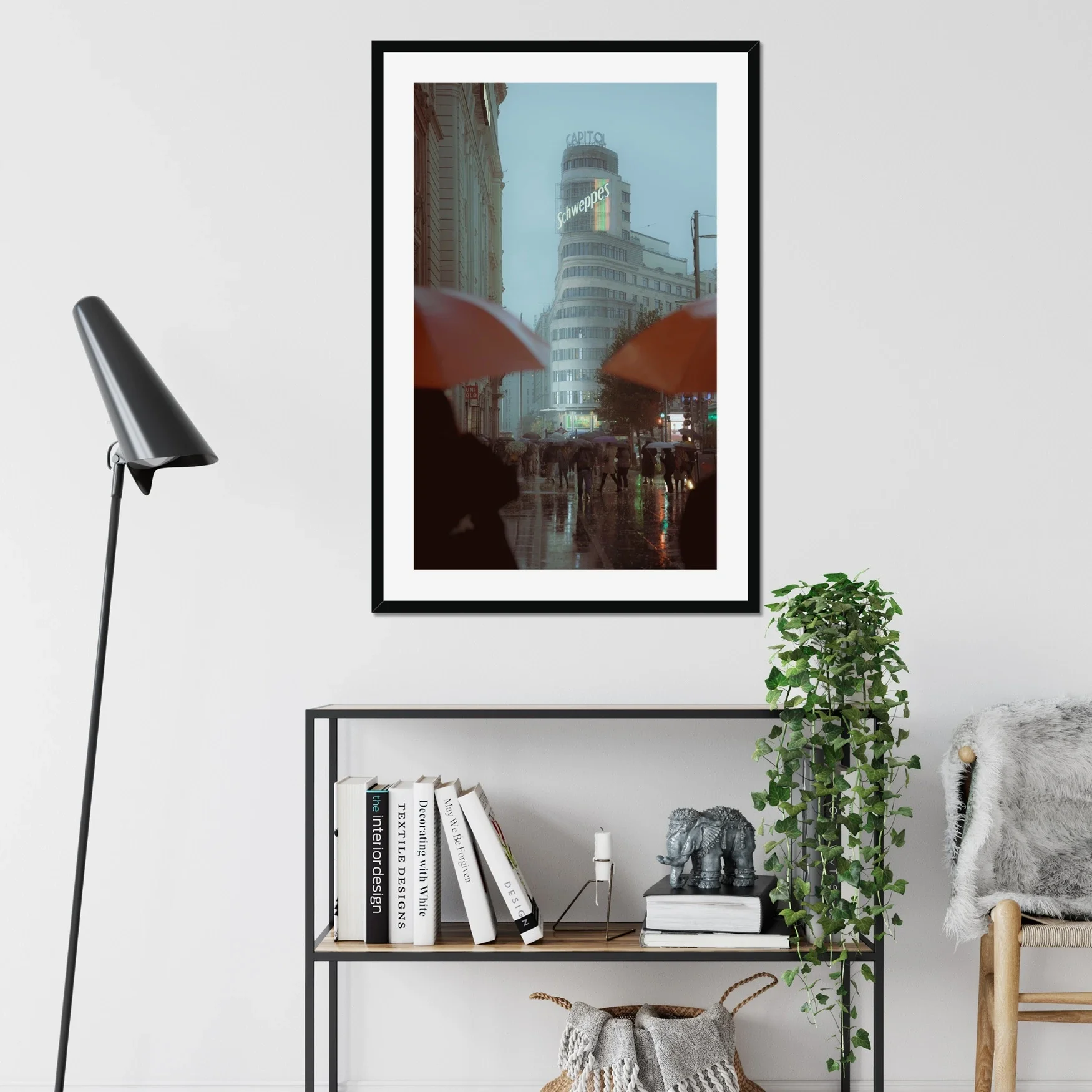 Cinematic street photography of Gran Via Madrid in the rain, featuring the Schweppes Capitol building, a sea of umbrellas, and wet street reflections at dusk.