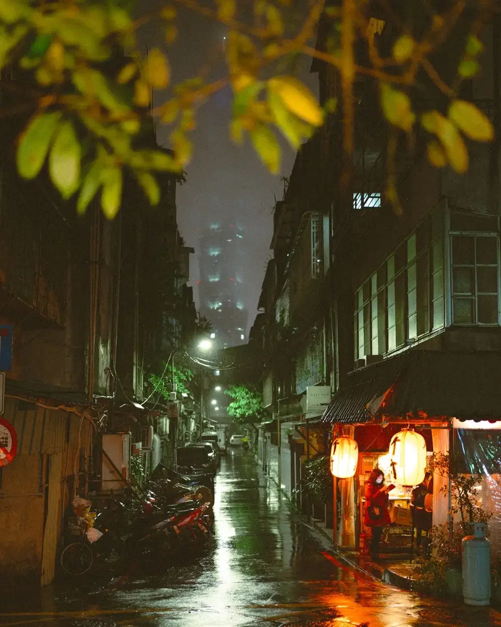 Before and after comparison using Lomography 800 Lightroom preset on a night street photography scene with vibrant neon lights and film grain.