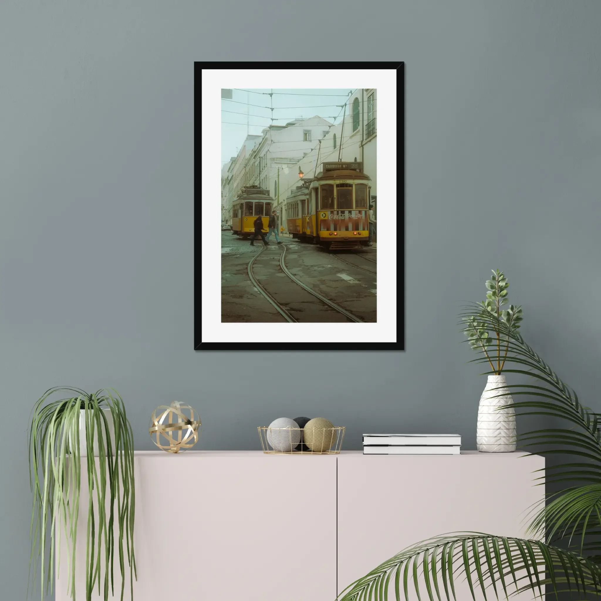 Cinematic fine art photography of Lisbon yellow Tram 28 and anonymous couple crossing tracks in moody morning fog.