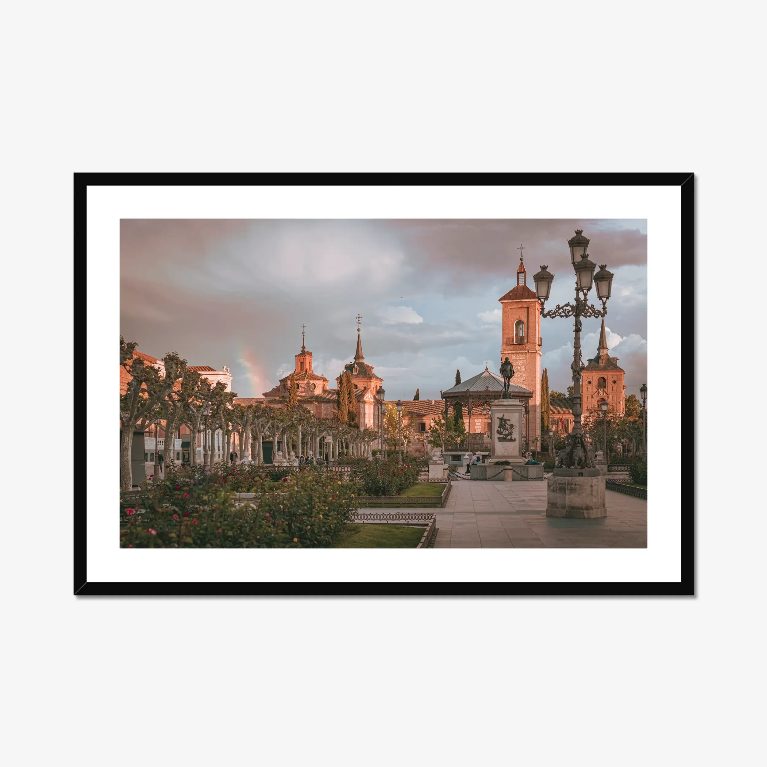 Fine art photography of Plaza de Cervantes in Alcala de Henares, Madrid, featuring a rainbow and dramatic stormy sunset over the historic square.