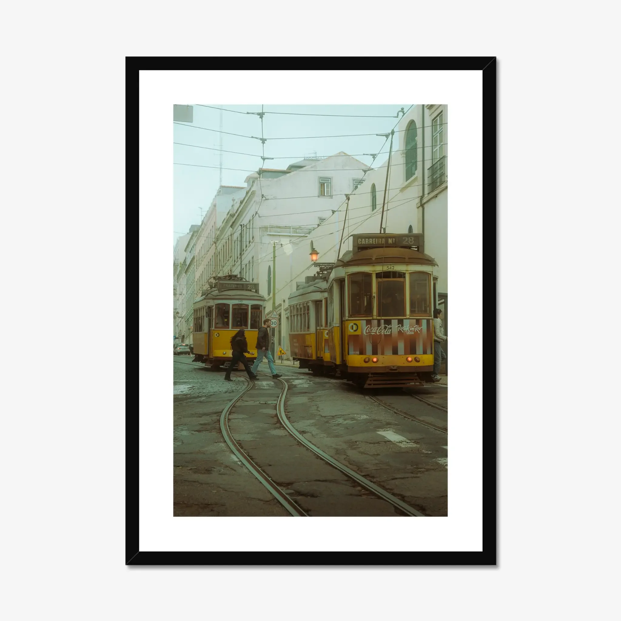 Cinematic fine art photography of Lisbon yellow Tram 28 and anonymous couple crossing tracks in moody morning fog.