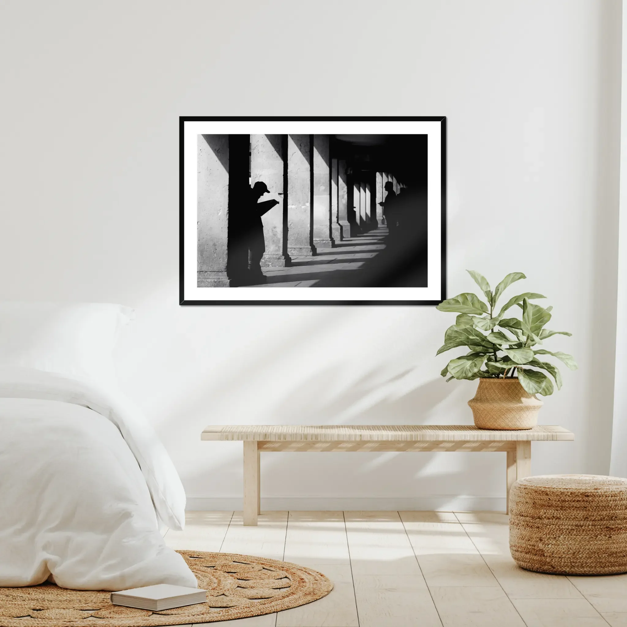 Black and white minimalist street photography print of a lone figure walking up an outdoor staircase. Features strong geometric lines and high-contrast dramatic shadows. Fine art wall decor.