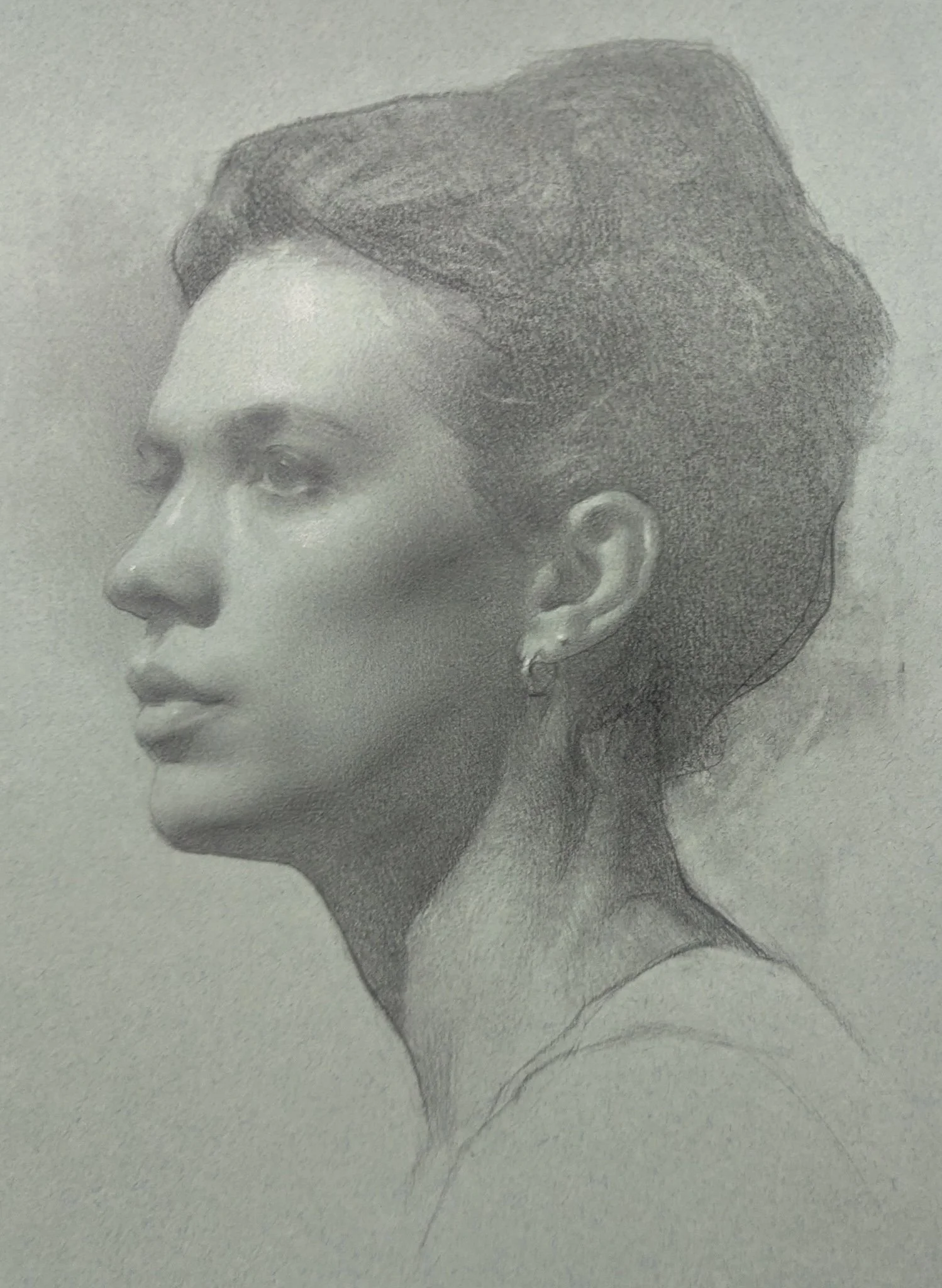 A detailed pencil sketch of a woman with her hair styled in an updo, wearing an earring, and gazing to the left.
