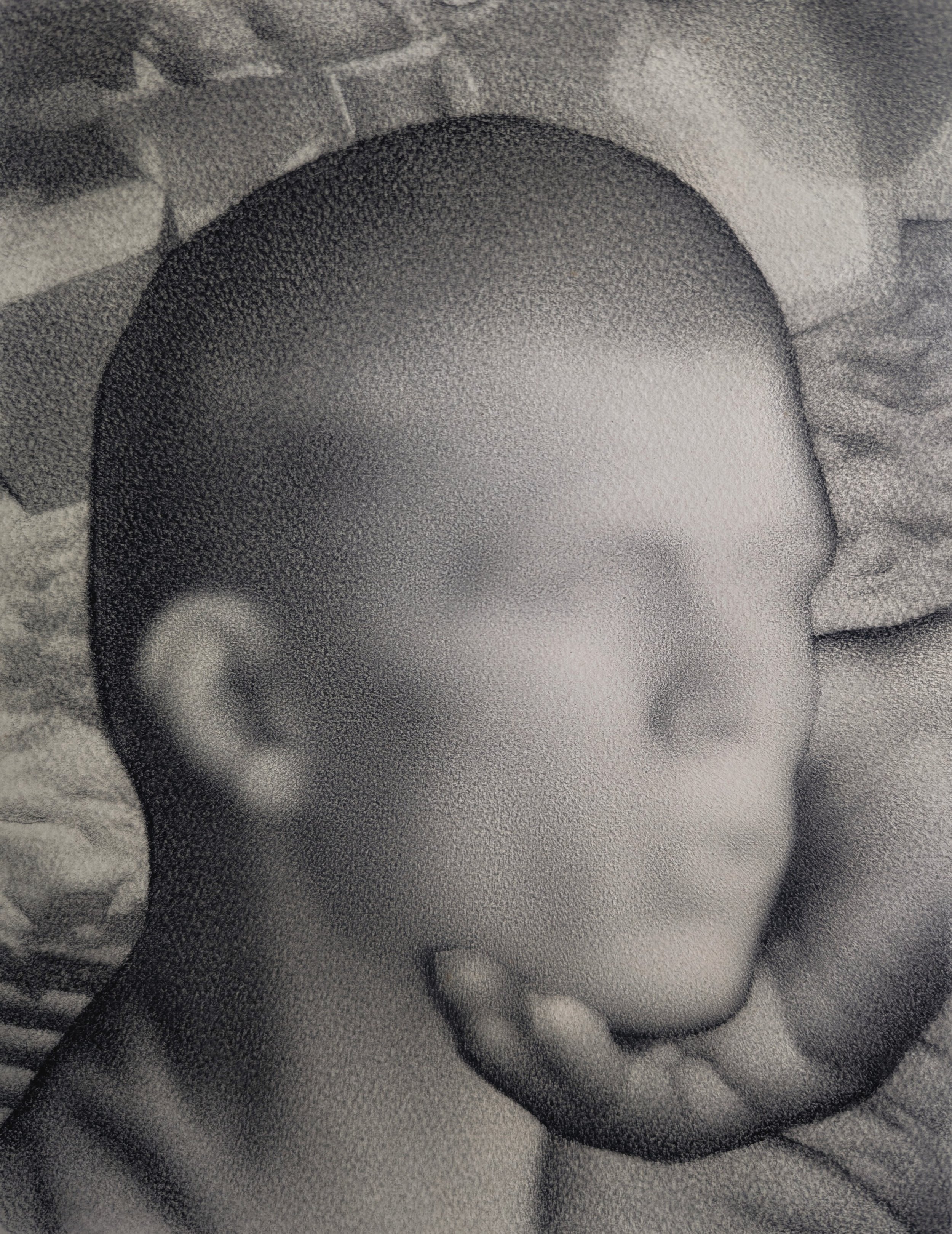Black and white portrait of a baby with a smooth shaved head, closed eyes, and hand resting on chin, lying on a textured surface.
