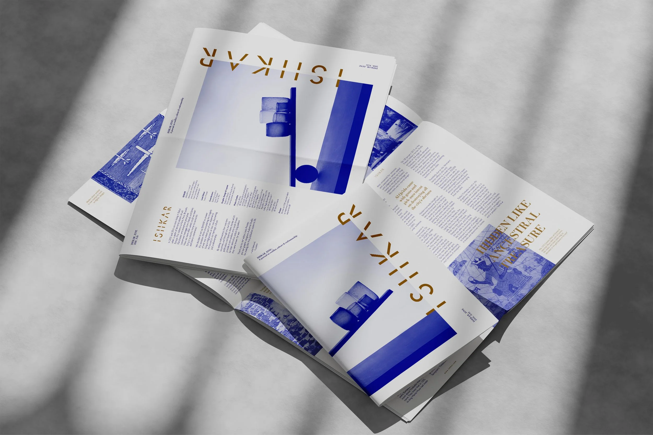 Open Ishkar Zine with blue-and-gold graphic designs, Ishkar Zine, craftsmanship from countries at war, editorial project by Automne Studio.