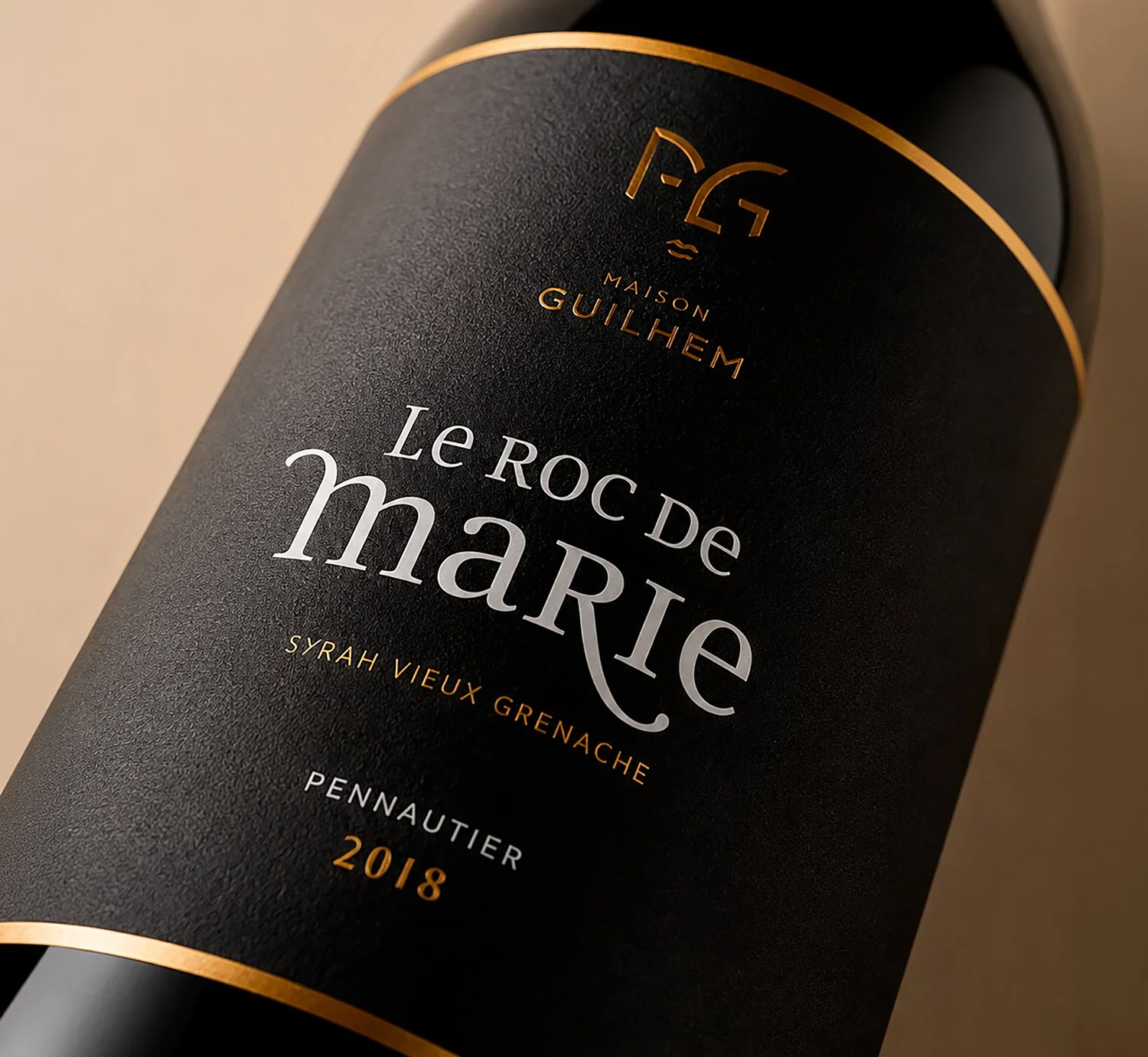 Close-up of a Maison Guilhem Le Roc de Marie Syrah Vieux Grenache red wine bottle, Pennautier 2018, Maison Guilhem, French vineyard, branding and editorial project by Automne Studio.