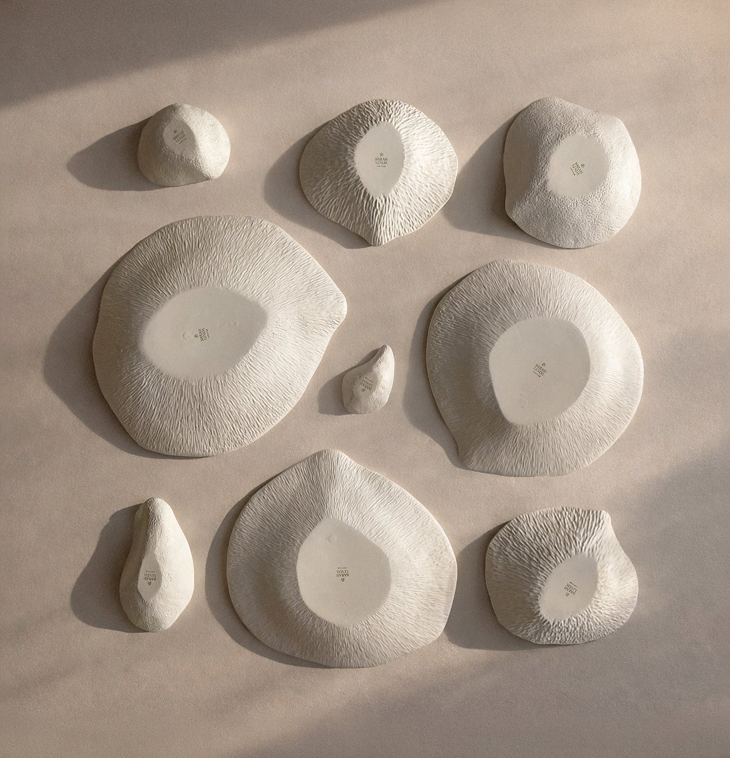 Collection of white textured ceramic plates, Indulge collection, Sarah-Linda, sensual tableware, branding, web design and editorial project by Automne Studio.