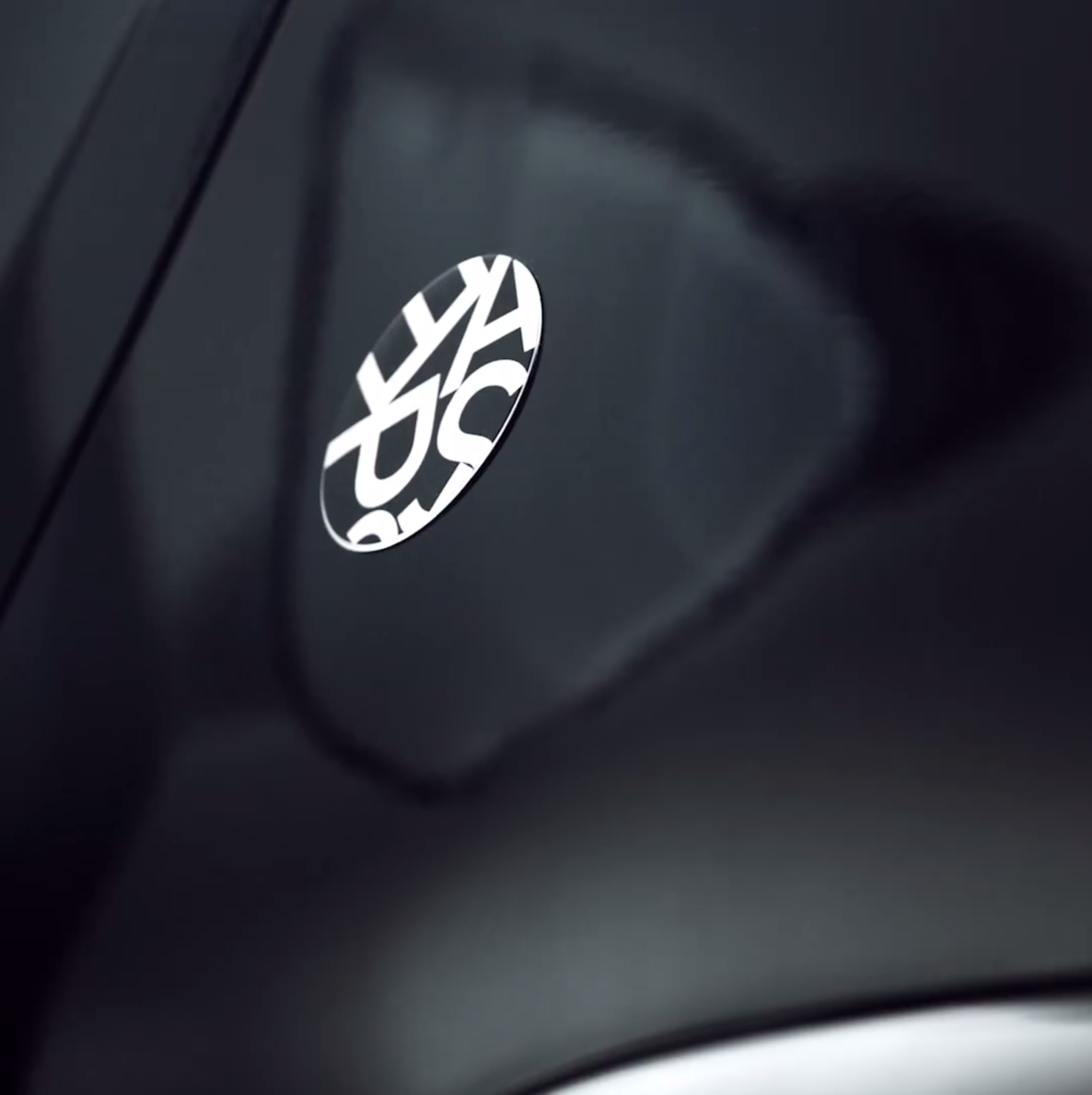 Close-up of a black Dacia Sandero Escape Limited Edition, typography by Automne Studio.