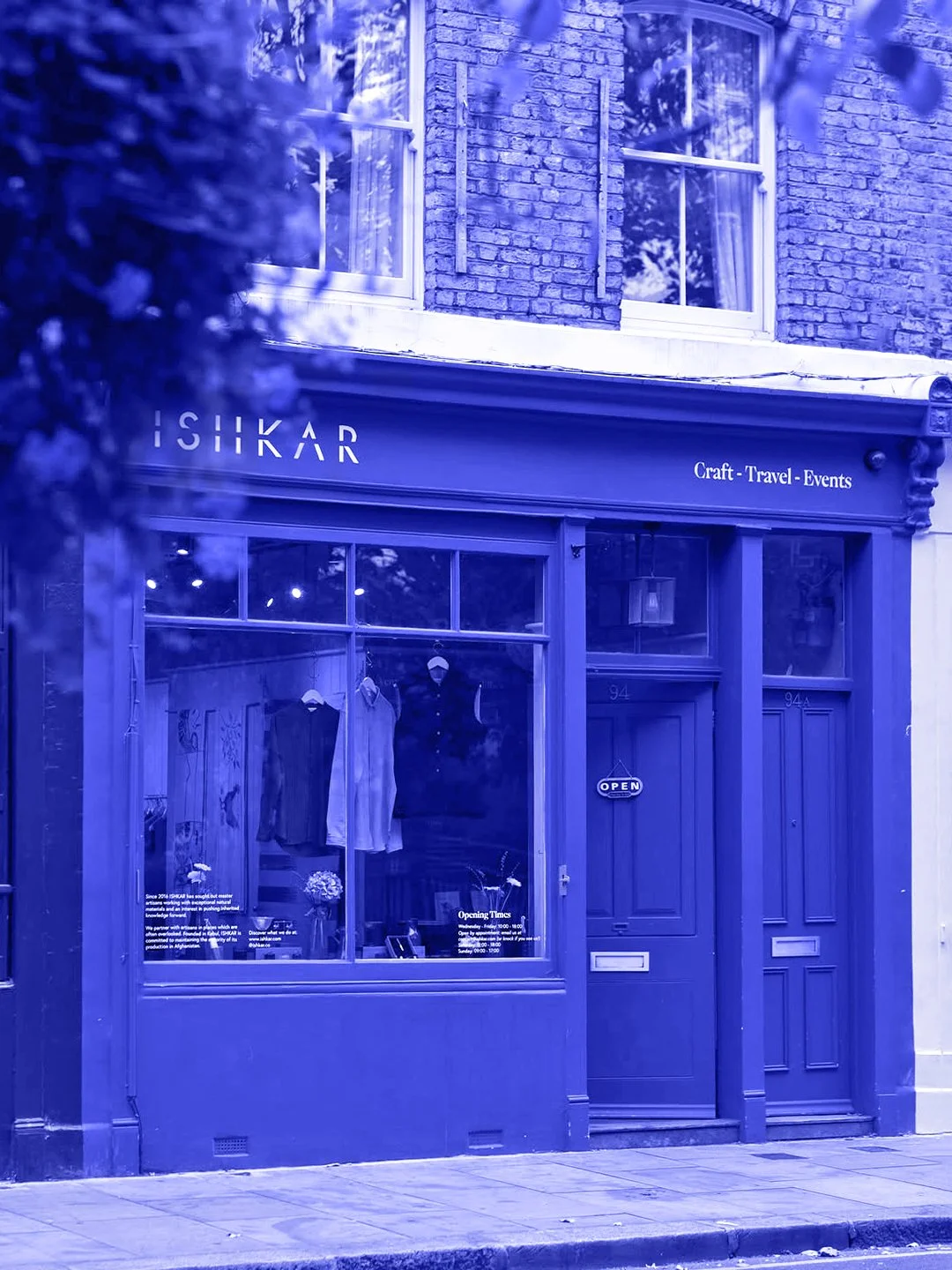 Blue-tinted storefront of ISHKAR, craftsmanship from countries at war, editorial project by Automne Studio.