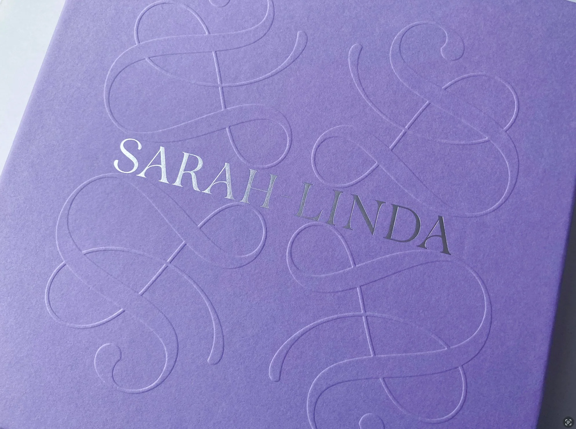 Lila purple Sarah-Linda tableware box, with oversized embossed and metallic serif lettering, sensual tableware, branding, web design and editorial project by Automne Studio.