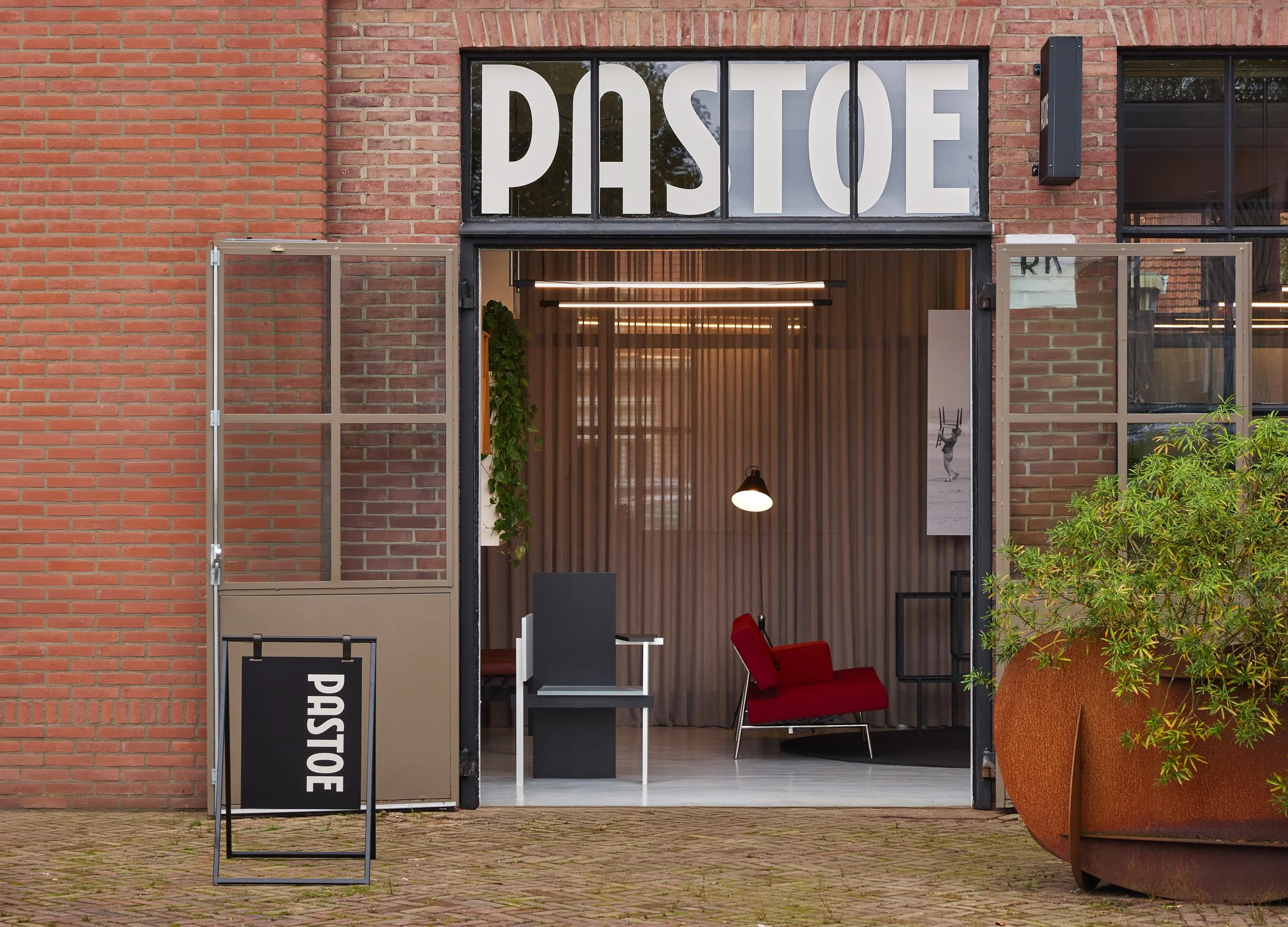Modern design studio entrance with large PASTOE window lettering, timeless dutch furniture design, branding project by Automne Studio.